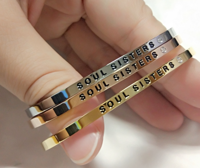 Olla adjustable stainless steel bangles with deep-engraved slogans like Live Laugh Love and Work Hard Play Hard at Sostter