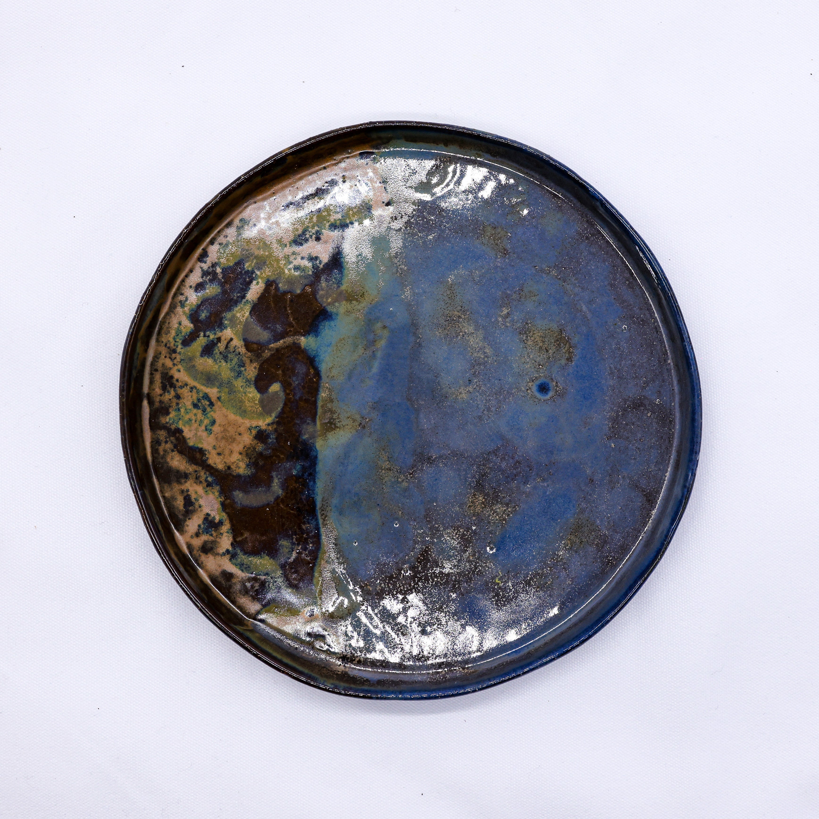 Contemporary ceramics by independent pottery artists, including hand-thrown bowls and stoneware vessels, curated by Sostter.