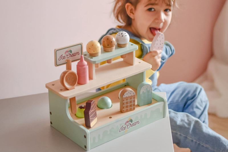 Child playing with eco wooden toys by Woopie lets go green on Sostter