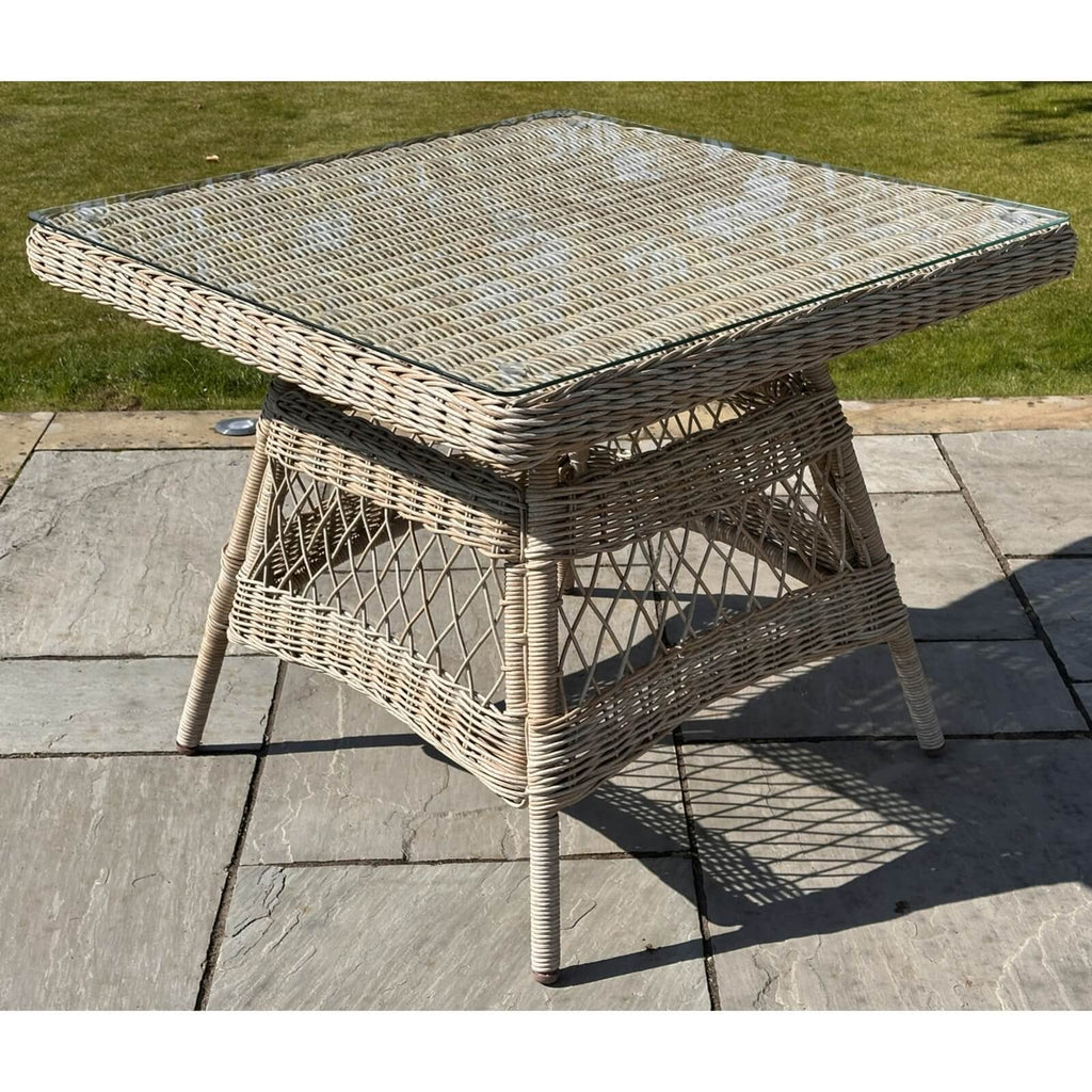 Provence 4-seater outdoor dining set in beige HDPE rattan with aluminum frame, tempered glass table, and Olefin cushions by sostter at brixbailey.com