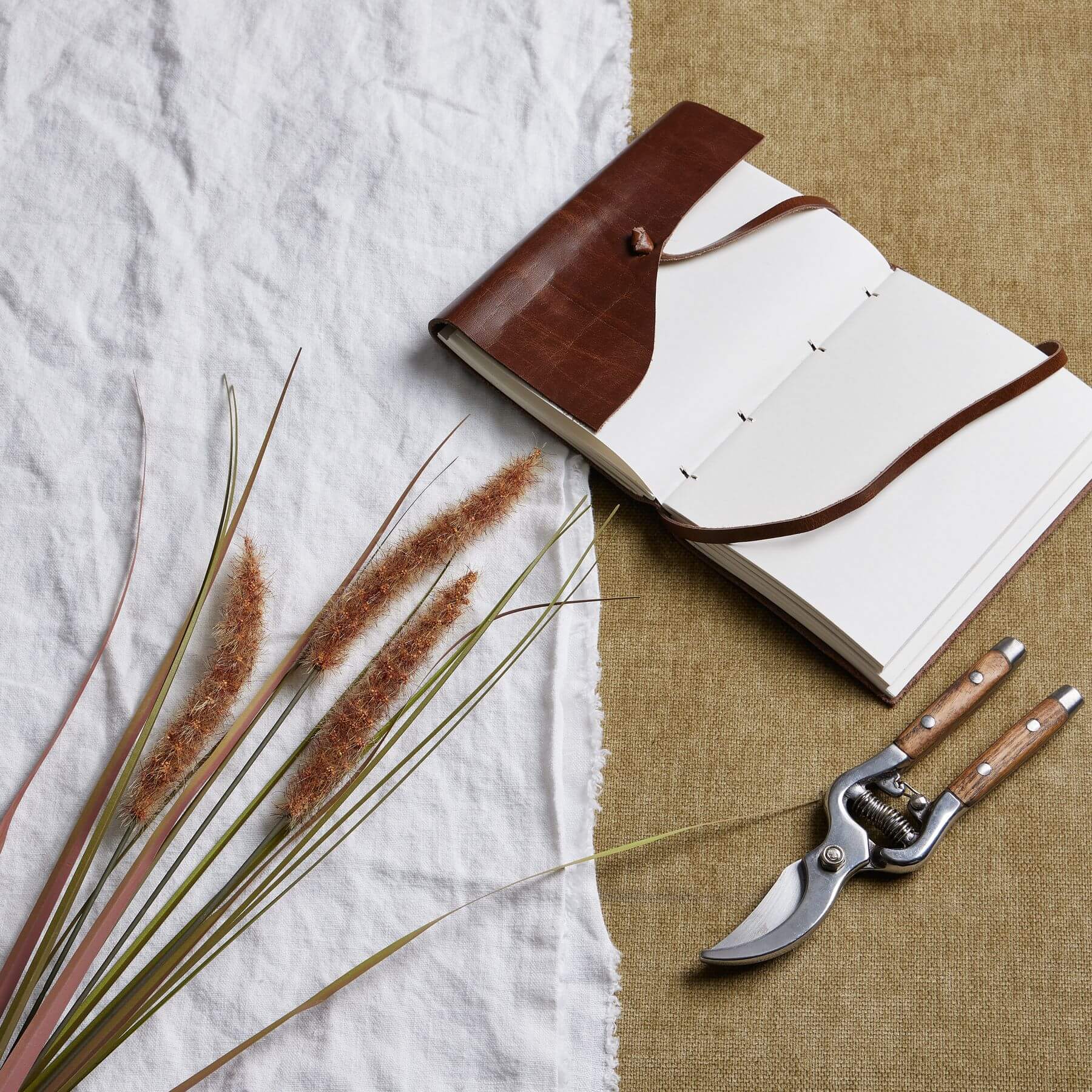 Three lifelike terracotta grass stems in warm brown, 80cm tall, for rustic or boho home decor by RoomLondon at brixbailey.com