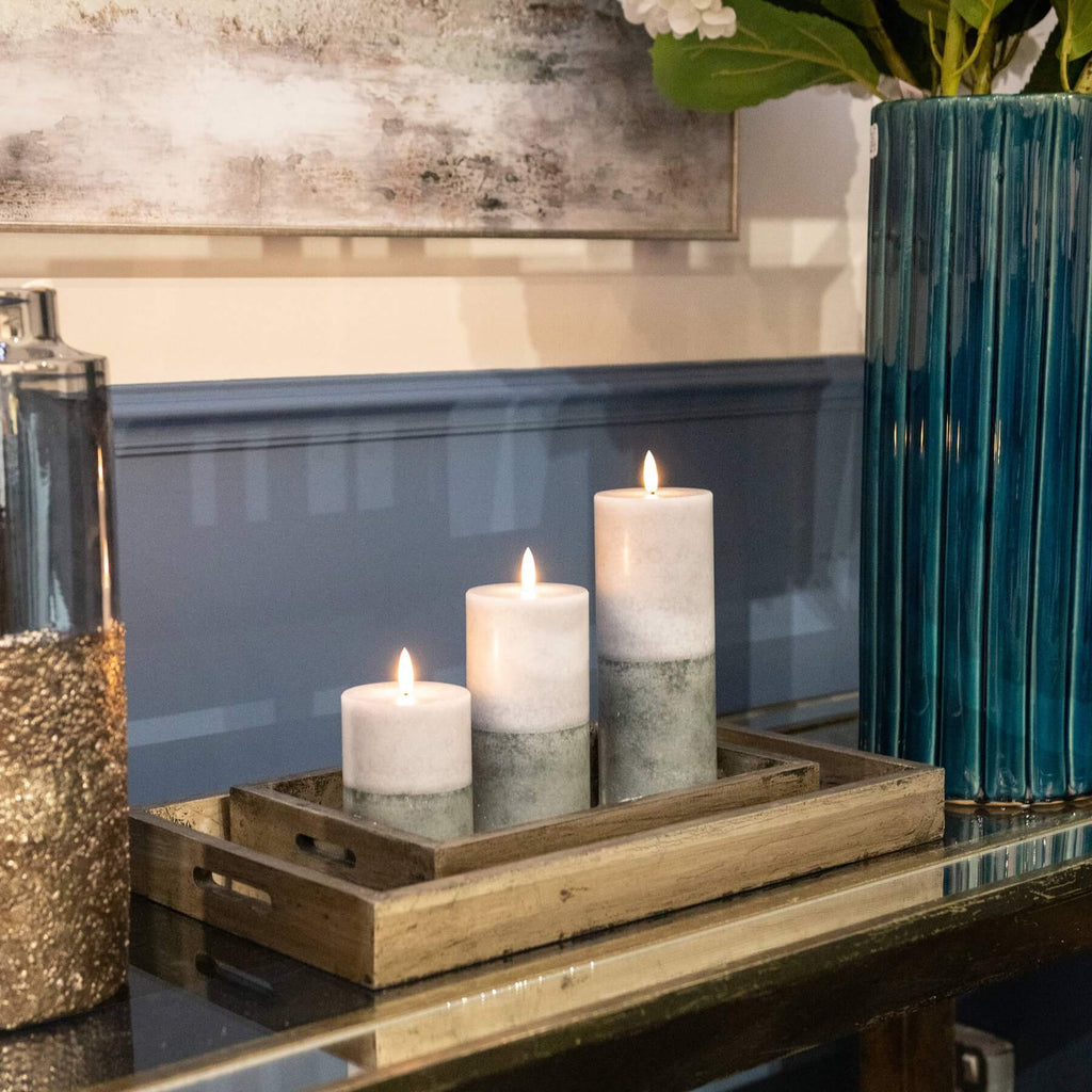 Premium LED candle with warm amber flicker, natural stone finish, and realistic two-tone texture for elegant decor. by Sostter at brixbailey.com