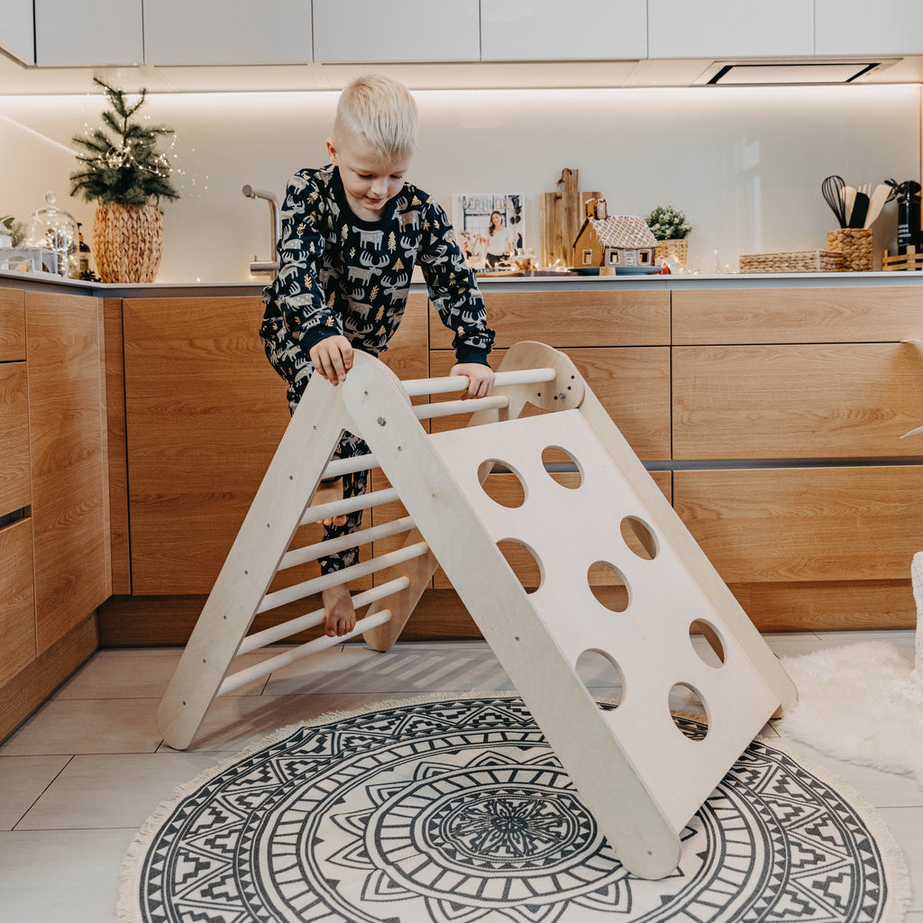 soft-lit montessori climbing triangle folded in cozy nursery, inviting toddlers to explore safely
