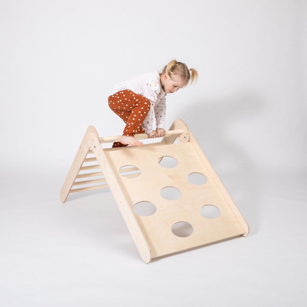 toddler climbing foldable montessori triangle in cozy nursery with soft natural lighting