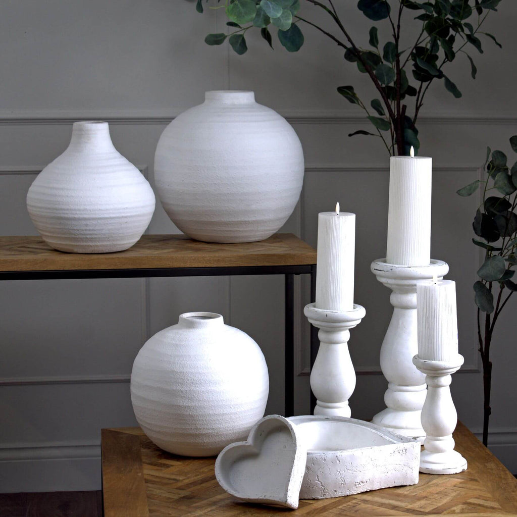 Handcrafted white ceramic candle holder with minimalist sculptural silhouette for modern decor. by RoomLondon at brixbailey.com
