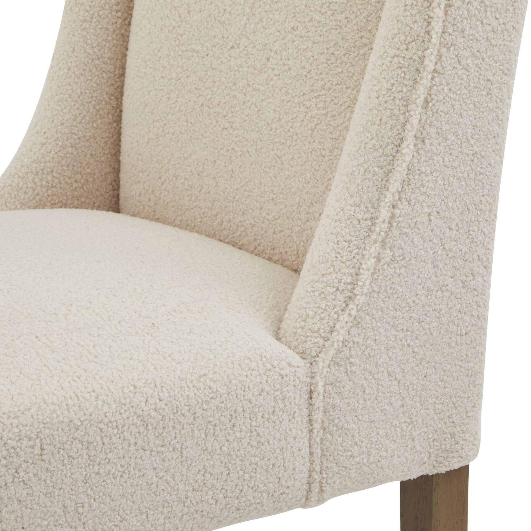 Cream bouclÃ© dining chair with rubberwood frame, modern silhouette, and quiet luxury aesthetic by Sostter at brixbailey.com