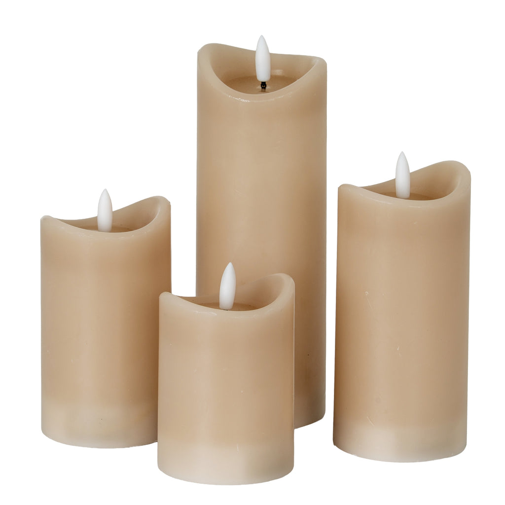 a playful close-up of the taupe led candle's quirky melted top, glowing warmly on a birthday table