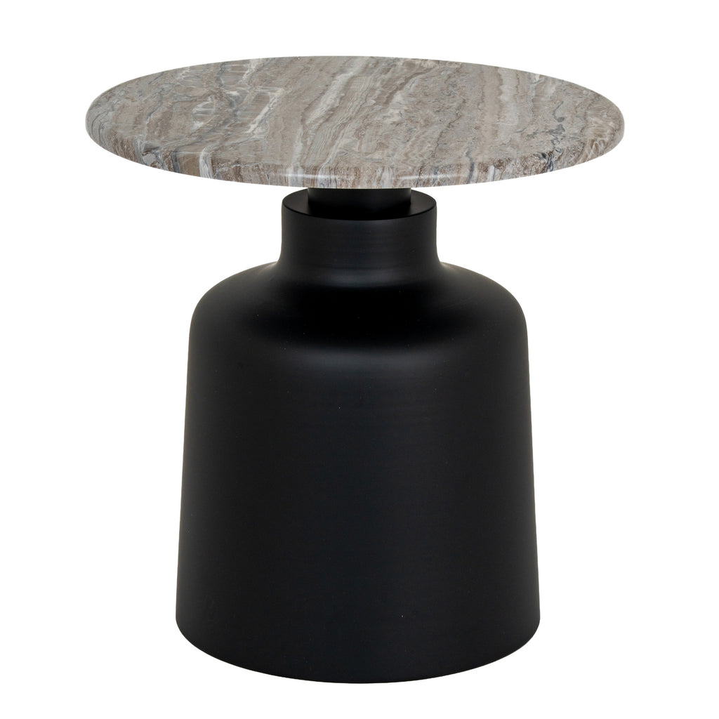 bold round black metal side table with sculpted tapered legs in dramatic low-light