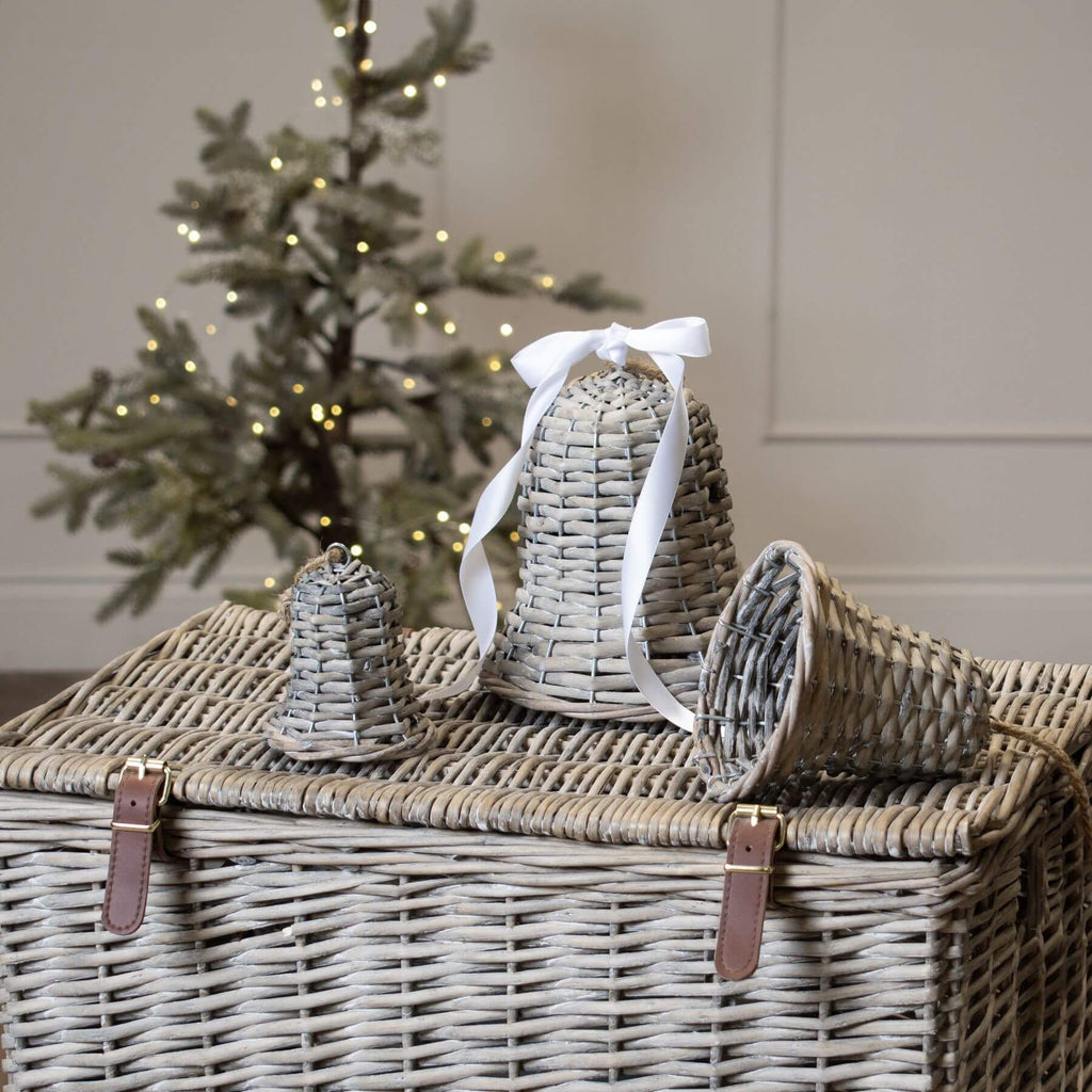 Handwoven wicker holiday bell in rich brown, 15cm tall, casting delicate shadow patterns when lit for festive decor. by sostter at brixbailey.com