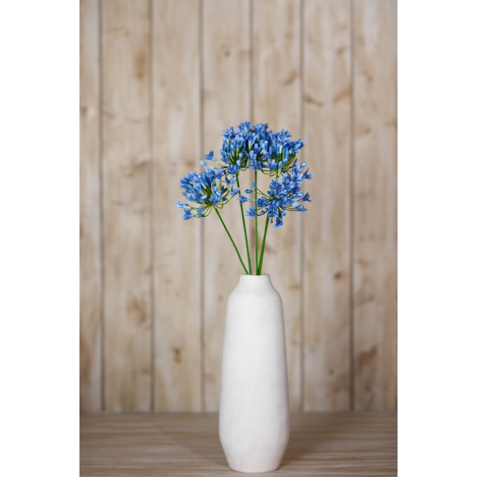 Blue Agapanthus artificial stem with vibrant true blue petals, lifelike botanical details, and 75cm height for home decor. by Sostter at brixbailey.com