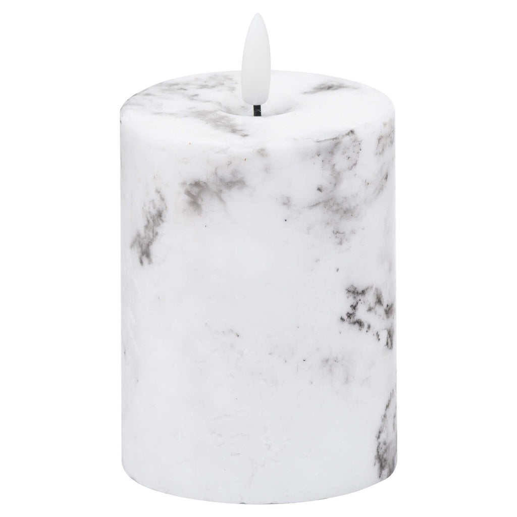 White marble-effect LED pillar candle with realistic flickering amber glow and unique veining patterns. by RoomLondon at brixbailey.com
