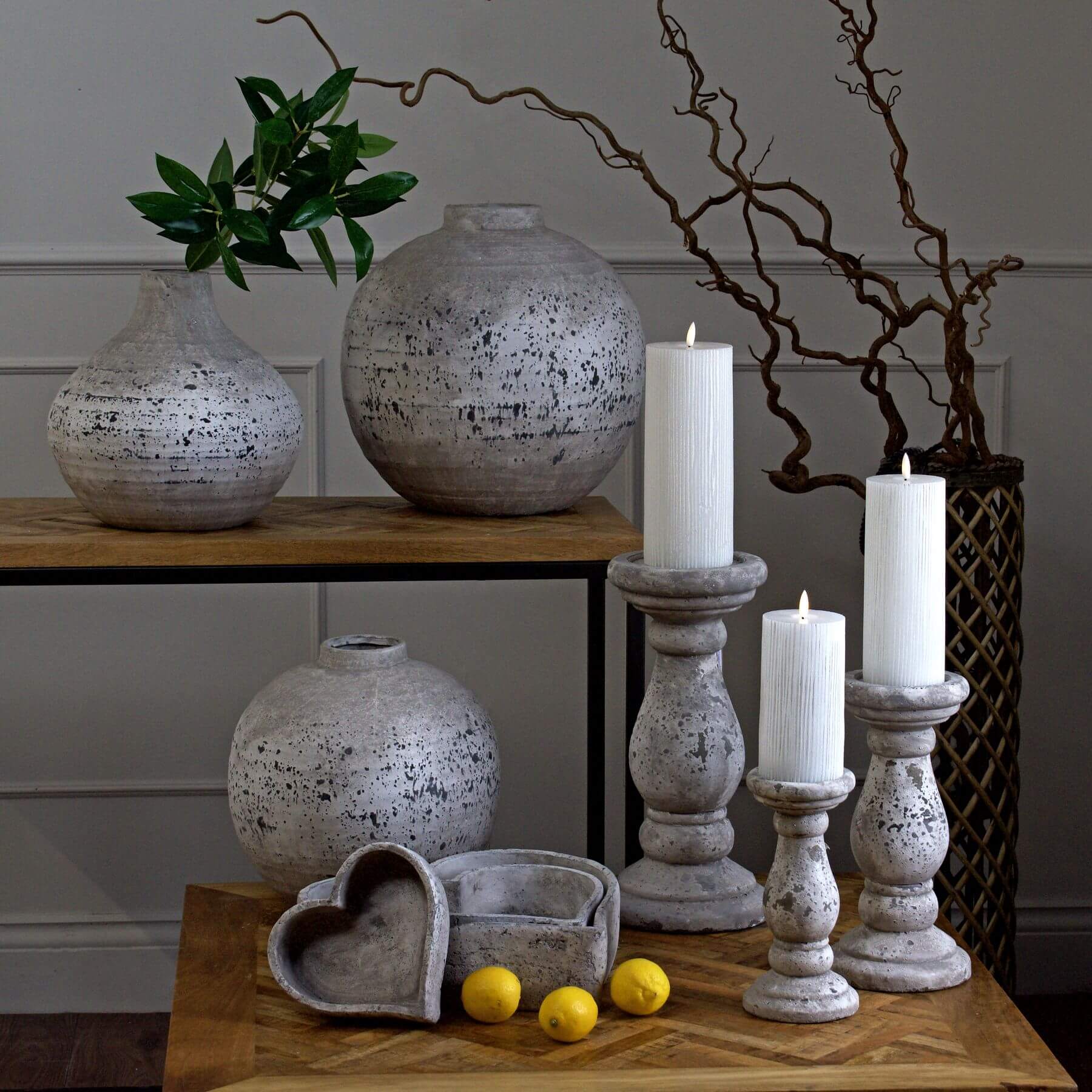 Handcrafted ceramic candle holder with natural stone texture in minimalist design, creating warm ambient lighting. by sostter at brixbailey.com