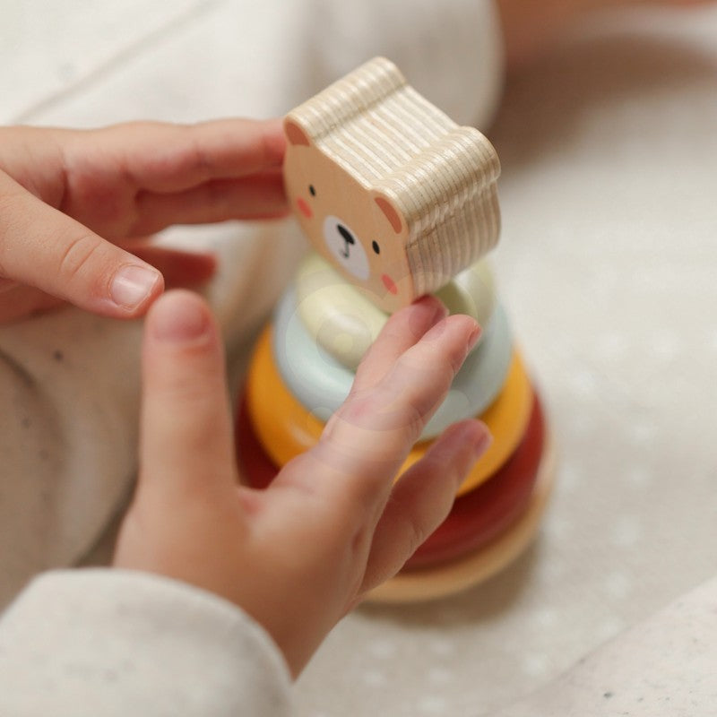 a toddler's hand pulling the cheerful wooden elephant on wheels from the 3in1 toy box set