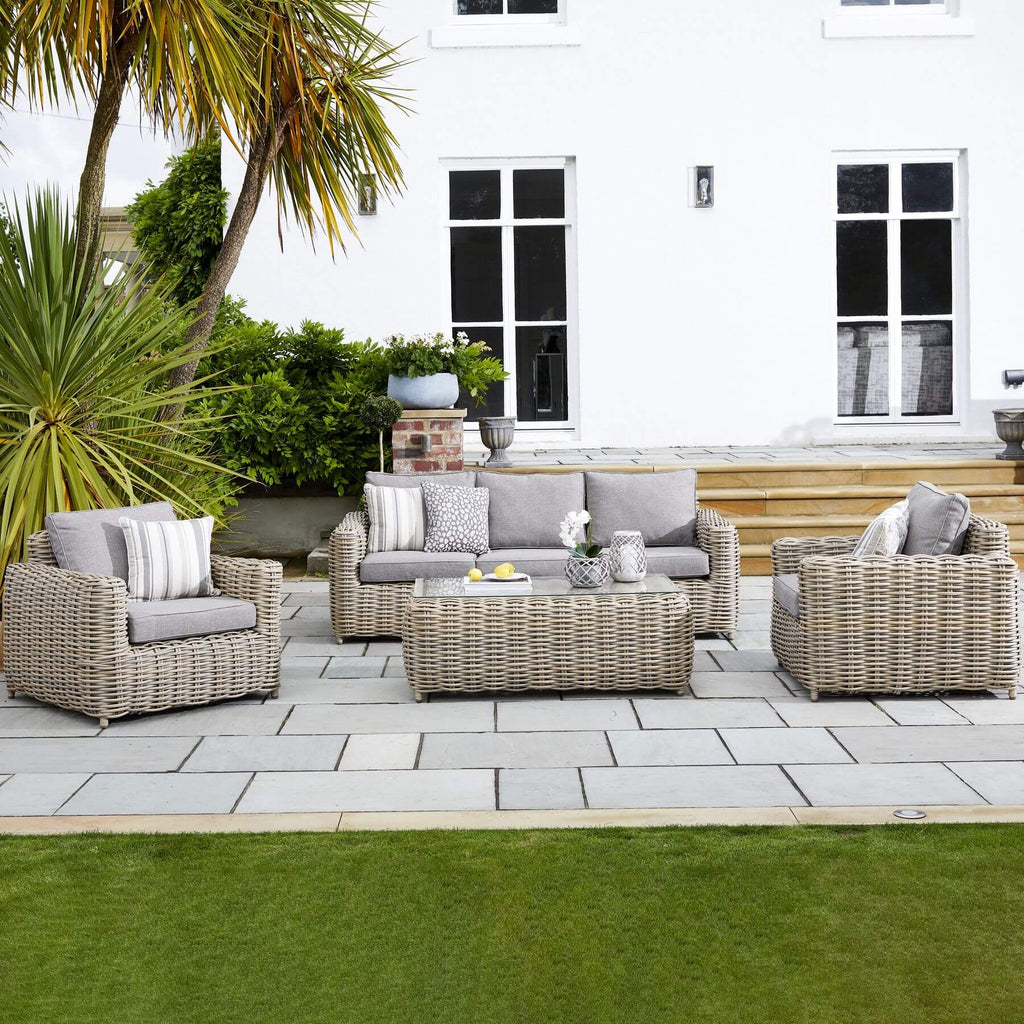 Premium beige HDPE wicker outdoor patio set with Olefin cushions and aluminum frame, includes coffee table by Sostter at brixbailey.com