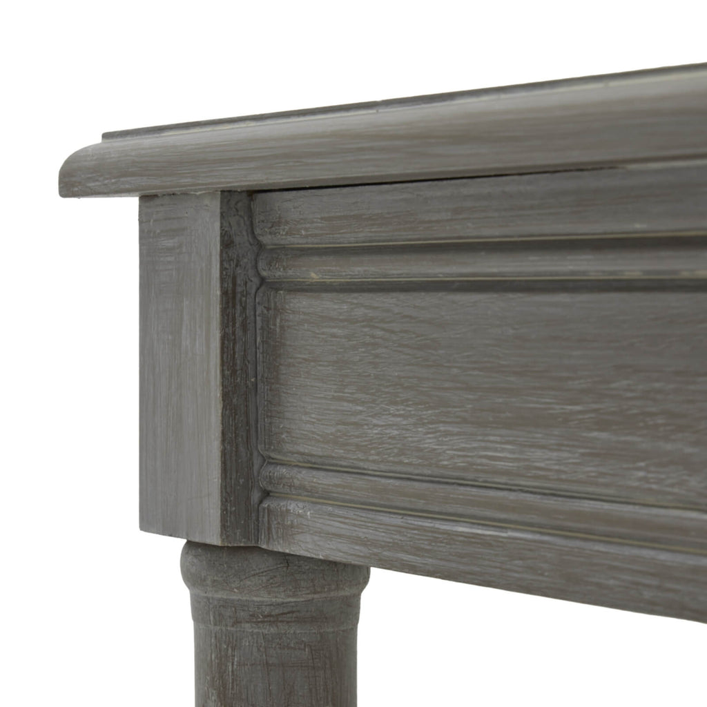 Handwoven rattan side table with soft grey finish, tapered legs, and organic texture for modern interiors. by RoomLondon at brixbailey.com