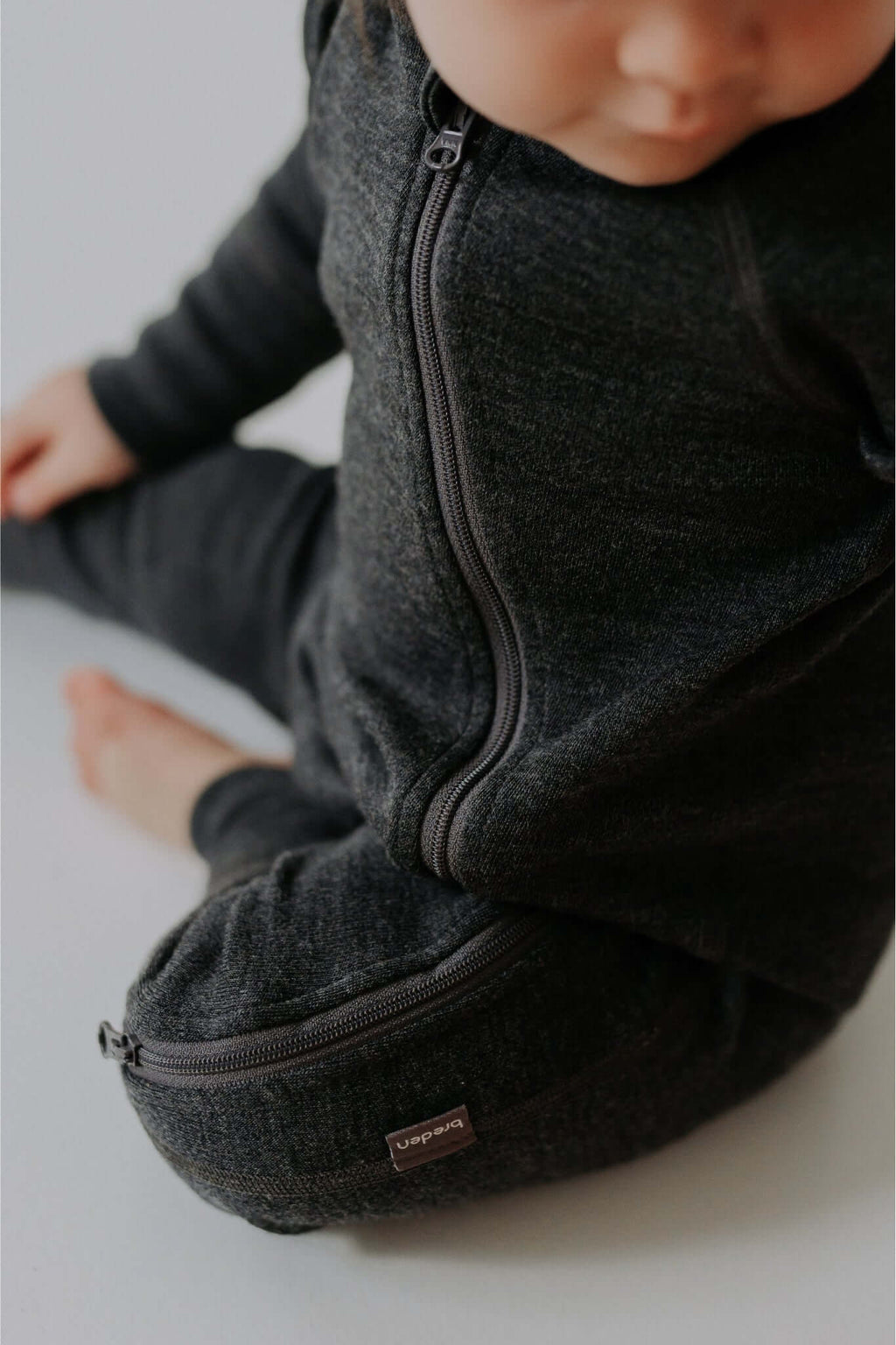 close-up of the smooth two-way zipper on a soft mulesing-free merino wool baby jumpsuit