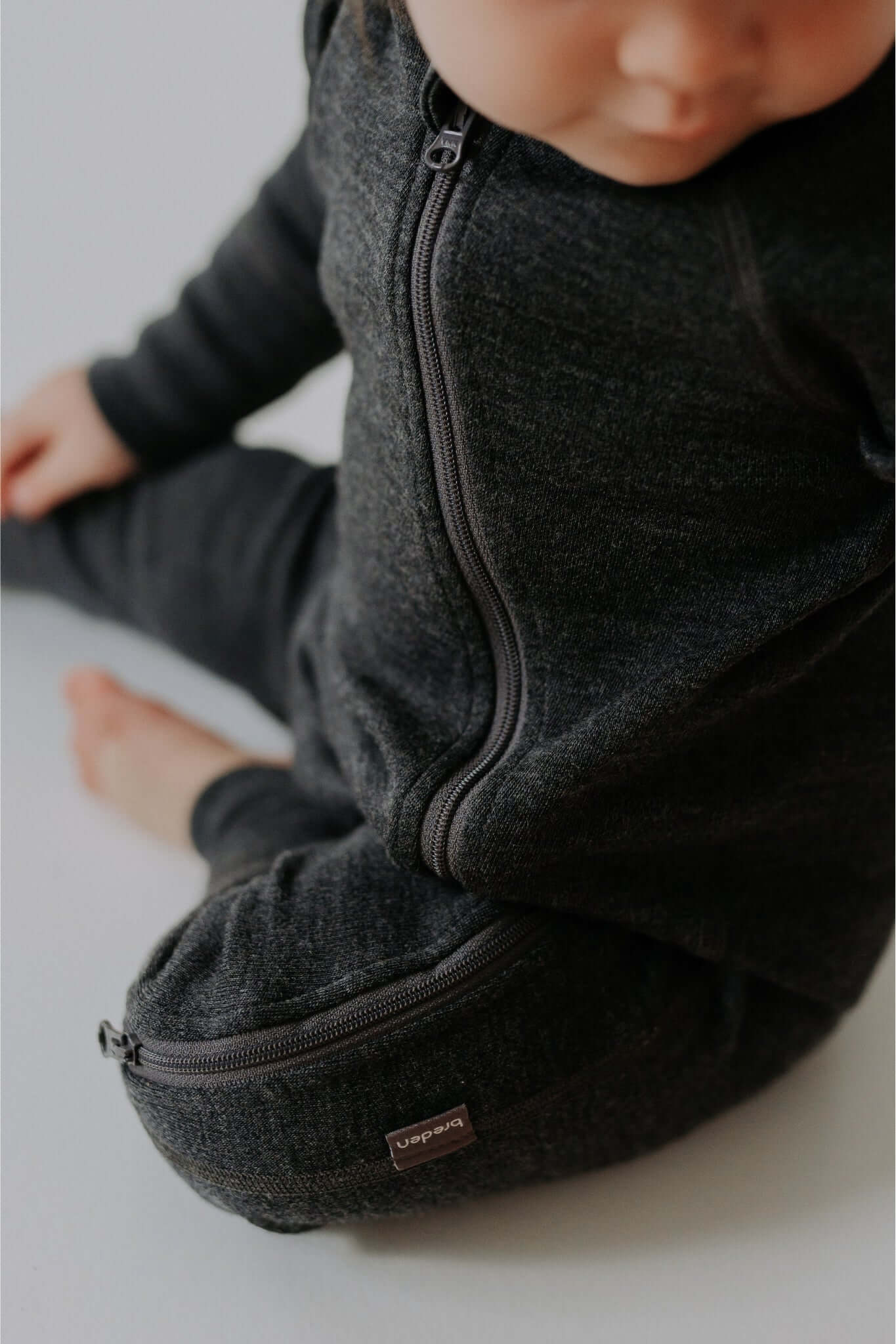 close-up of the smooth two-way zipper on a soft mulesing-free merino wool baby jumpsuit