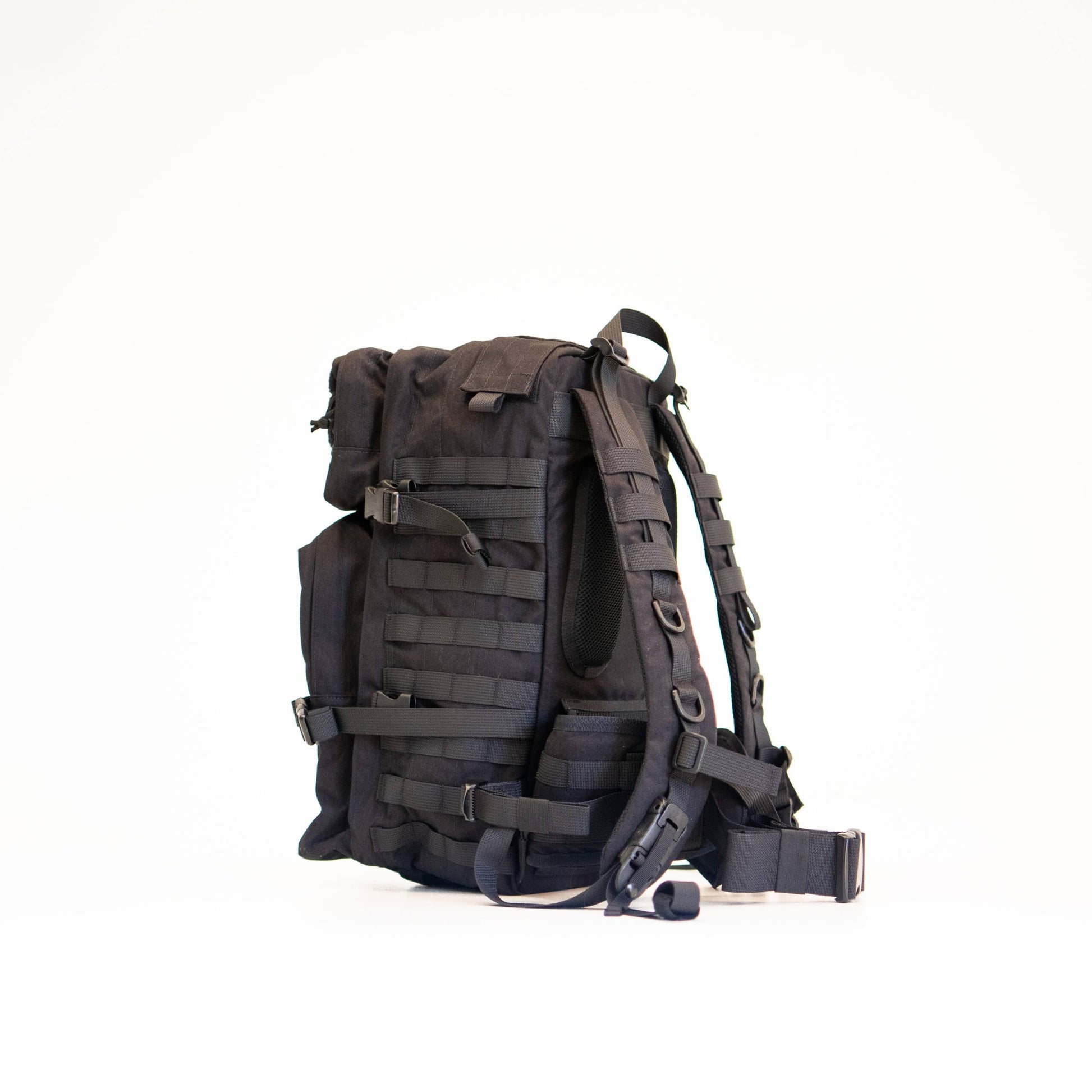 a soft-lit view of the black cordura backpack showing its comfortable padded shoulder straps and hip support