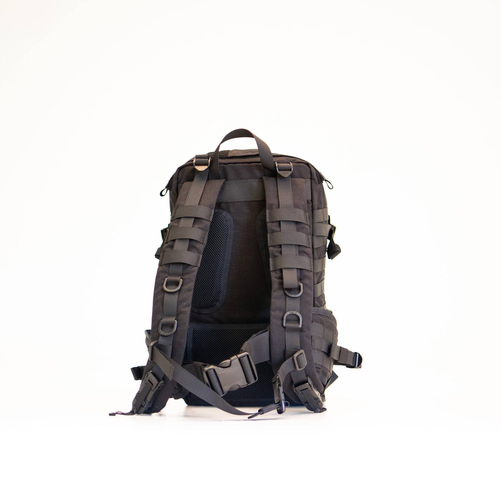 playful side view of the black galvi-linda backpack with molle straps in golden hour light