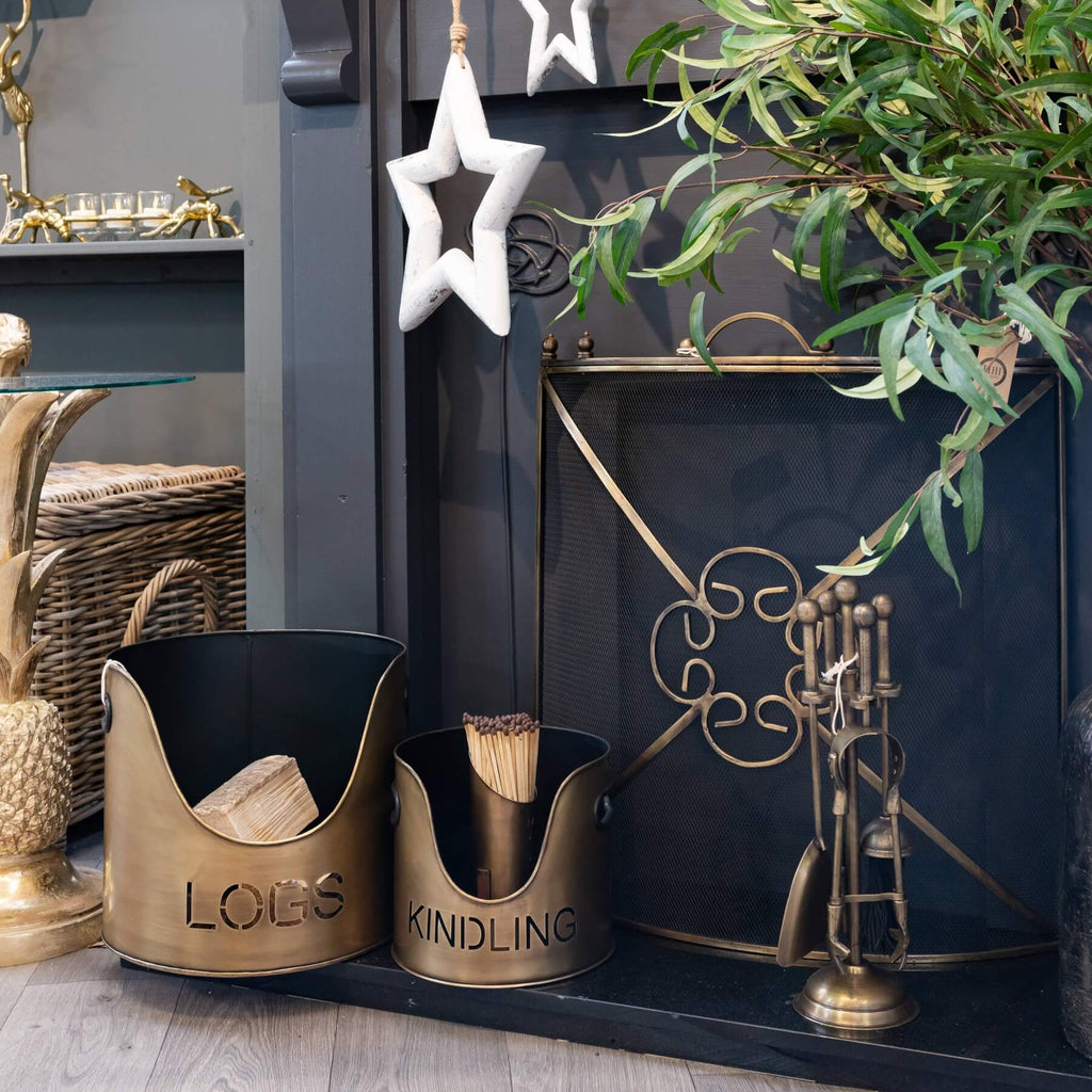 Antique bronze log and kindling set with cut-out detailing, 32cm tall, for stylish fireplace storage by Sostter at brixbailey.com