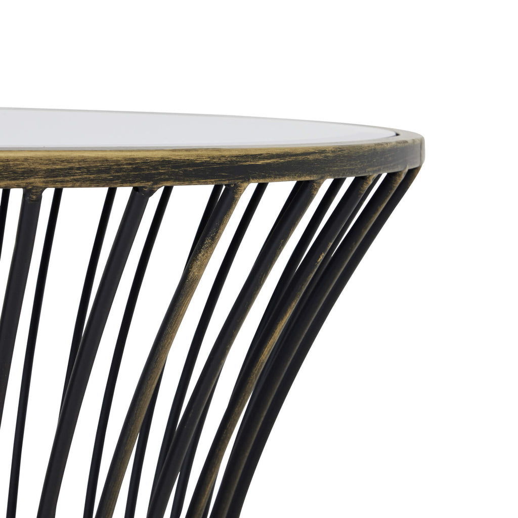 Handcrafted brass side table with black patina finish, mirrored glass top, and concave silhouette for modern interiors. by RoomLondon at brixbailey.com