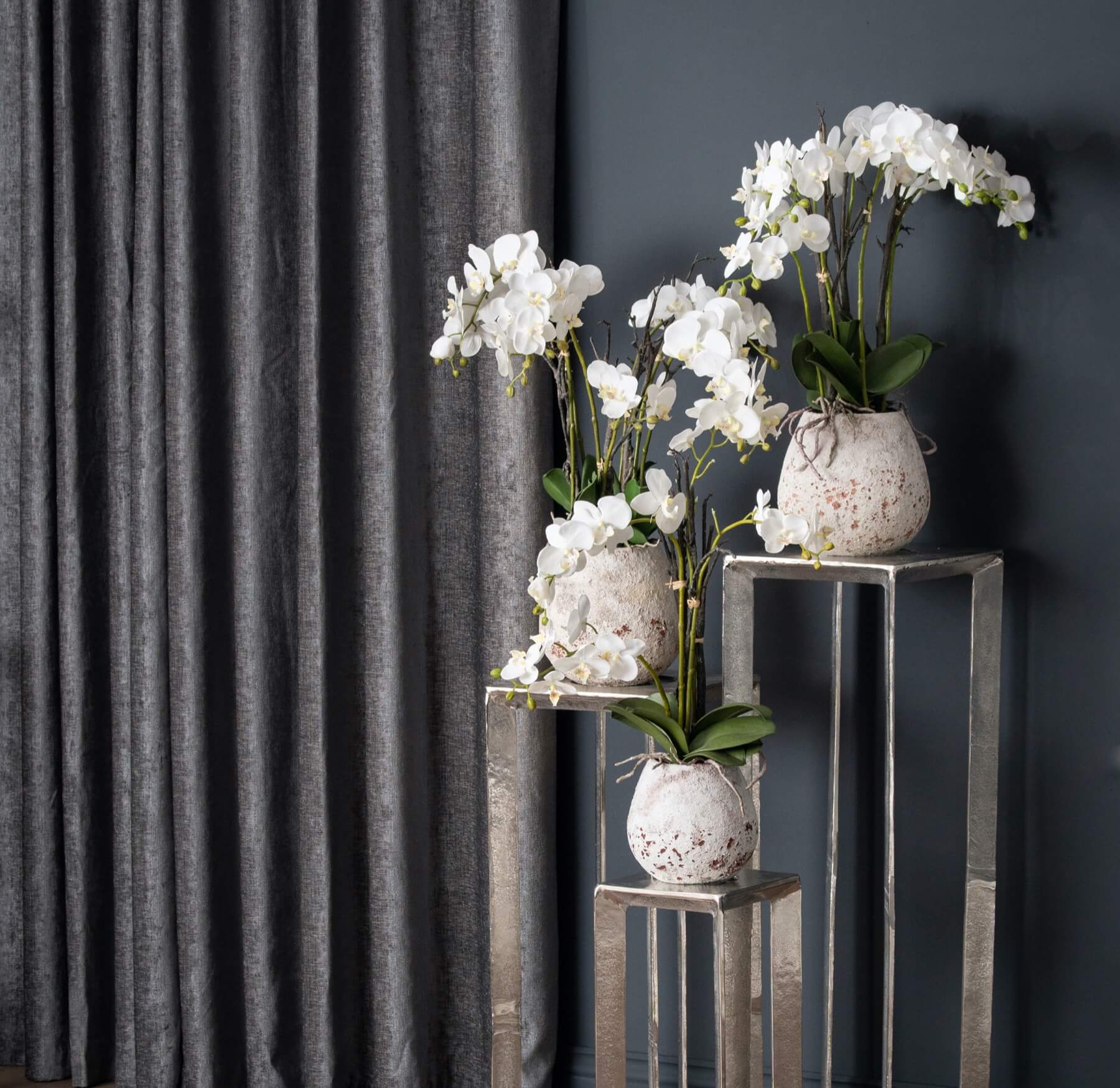 Lifelike white faux orchid in rustic stone pot, perfect for home decor, 70cm tall with realistic blooms and soil detailing by sostter at brixbailey.com