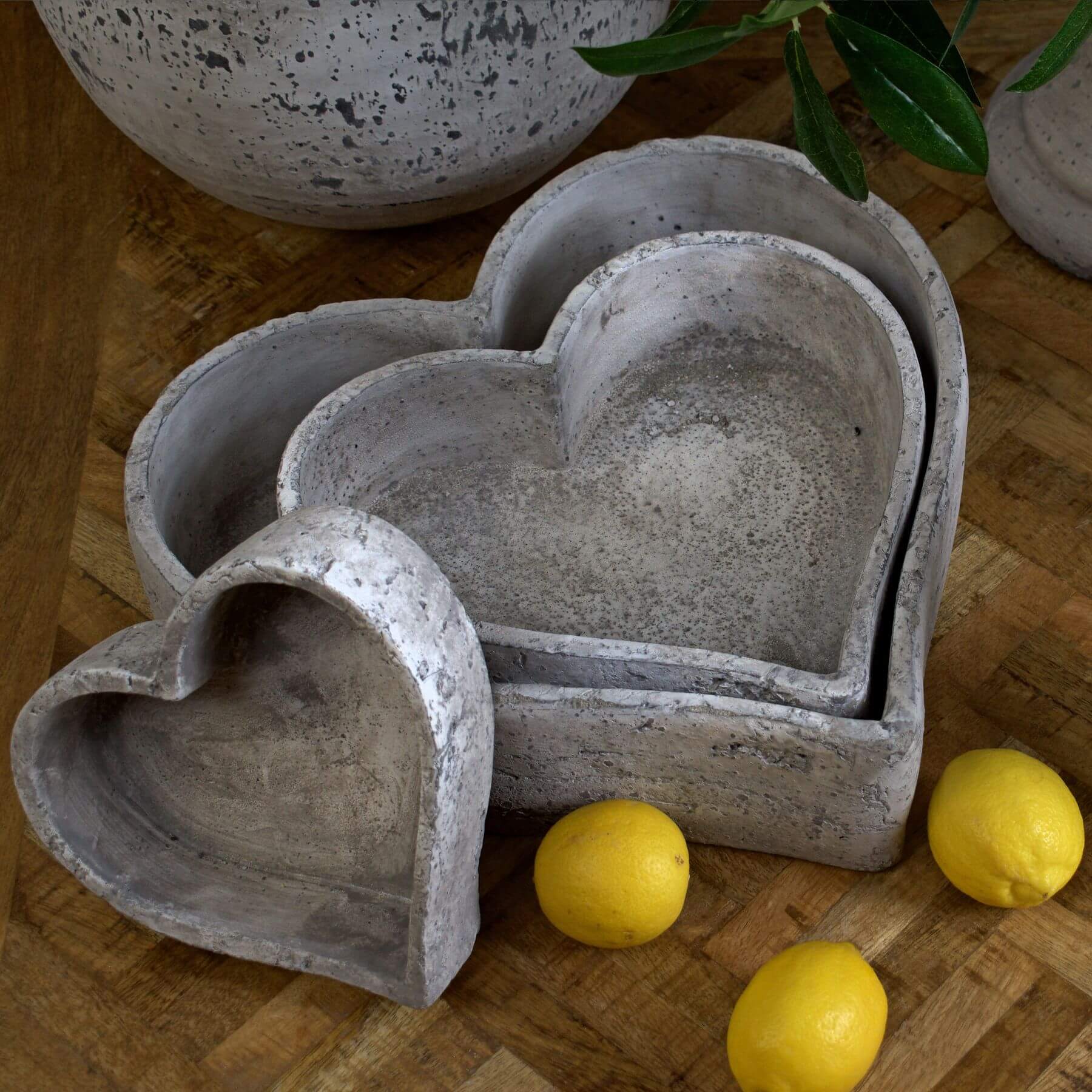 a playful stack of three textured stoneware dishes on a rustic wooden table