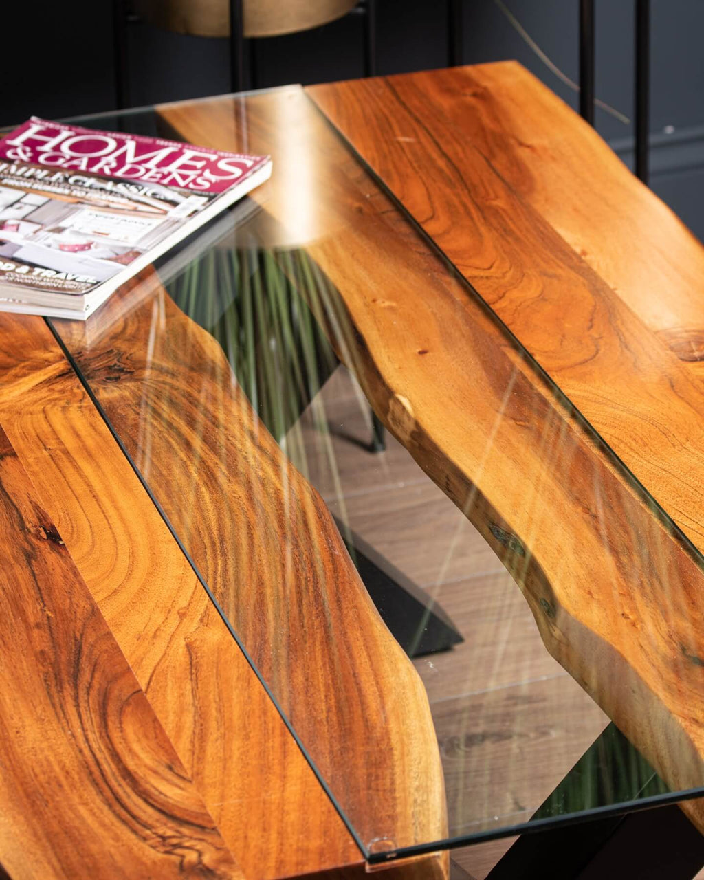 Live edge river dining table with tempered glass center and warm brown wood, modern rustic design by RoomLondon at brixbailey.com