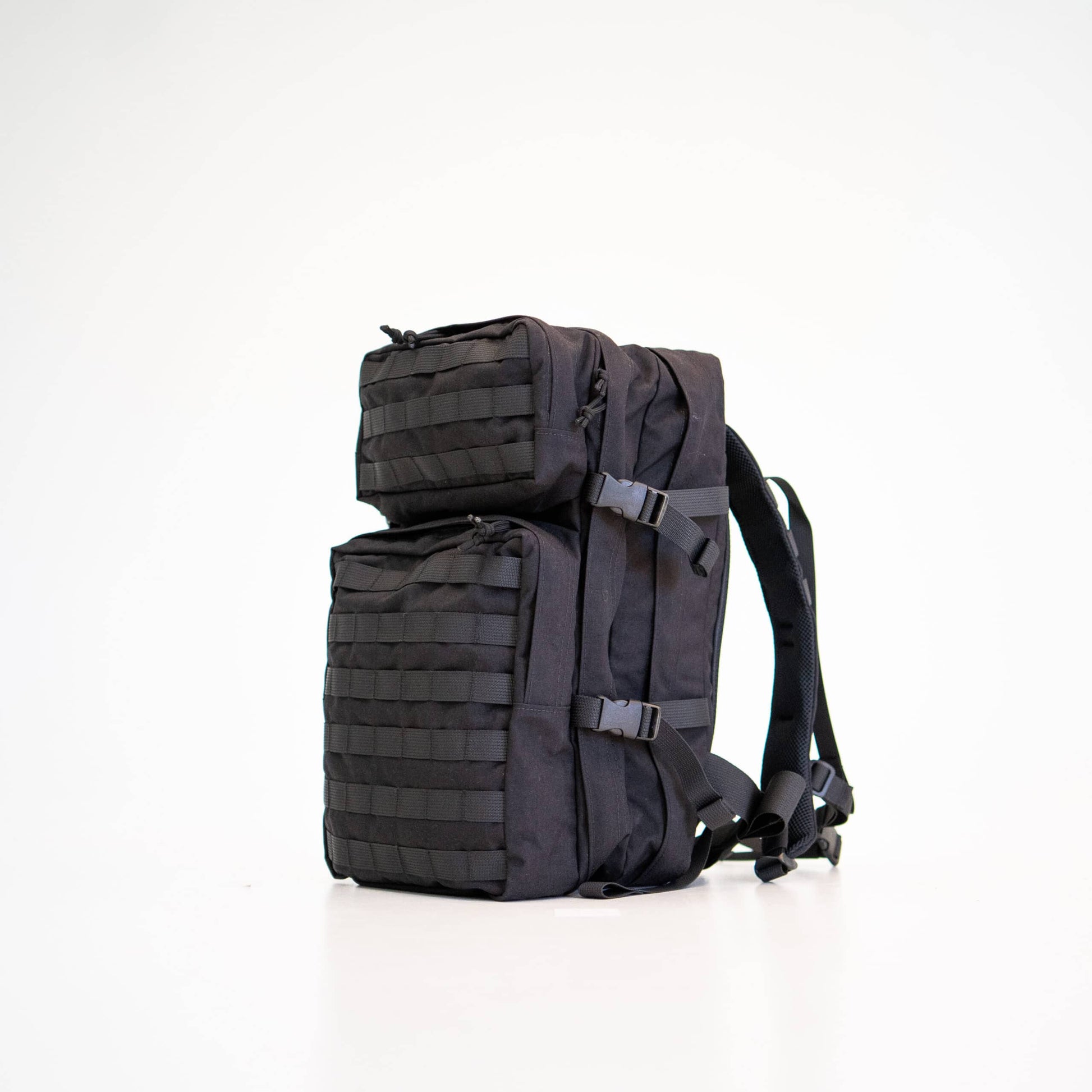 a playful shot of the durable black backpack with its compression straps cinched tight, ready for a fun day out