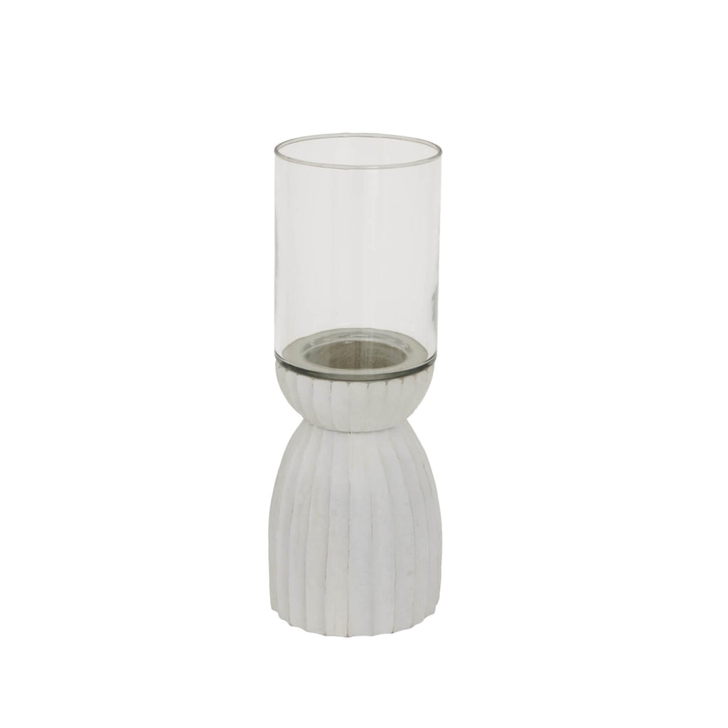 Handcrafted white hurricane lantern with intricate carved patterns, casting ambient light for home decor. by RoomLondon at brixbailey.com