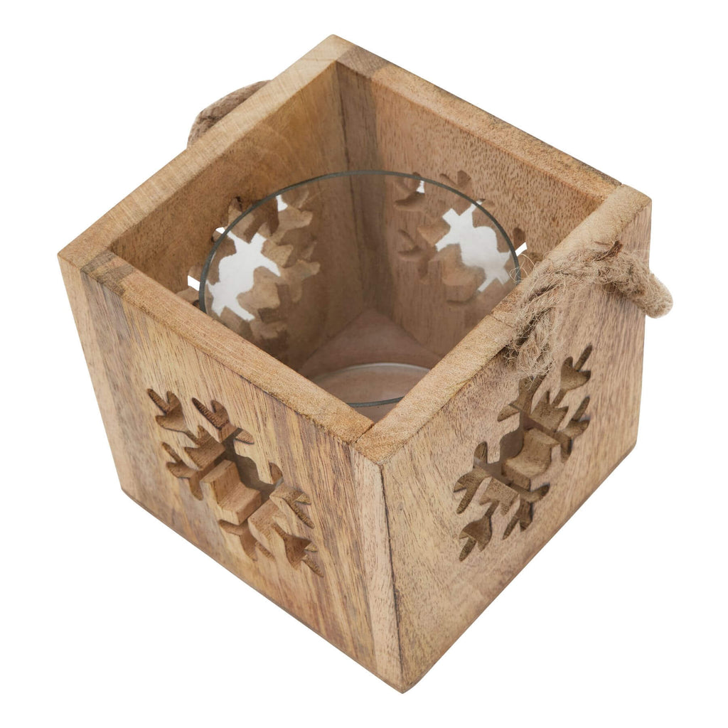 Handcrafted wooden snowflake tealight holder with glass insert, warm brown rustic decor for winter ambiance. by RoomLondon at brixbailey.com