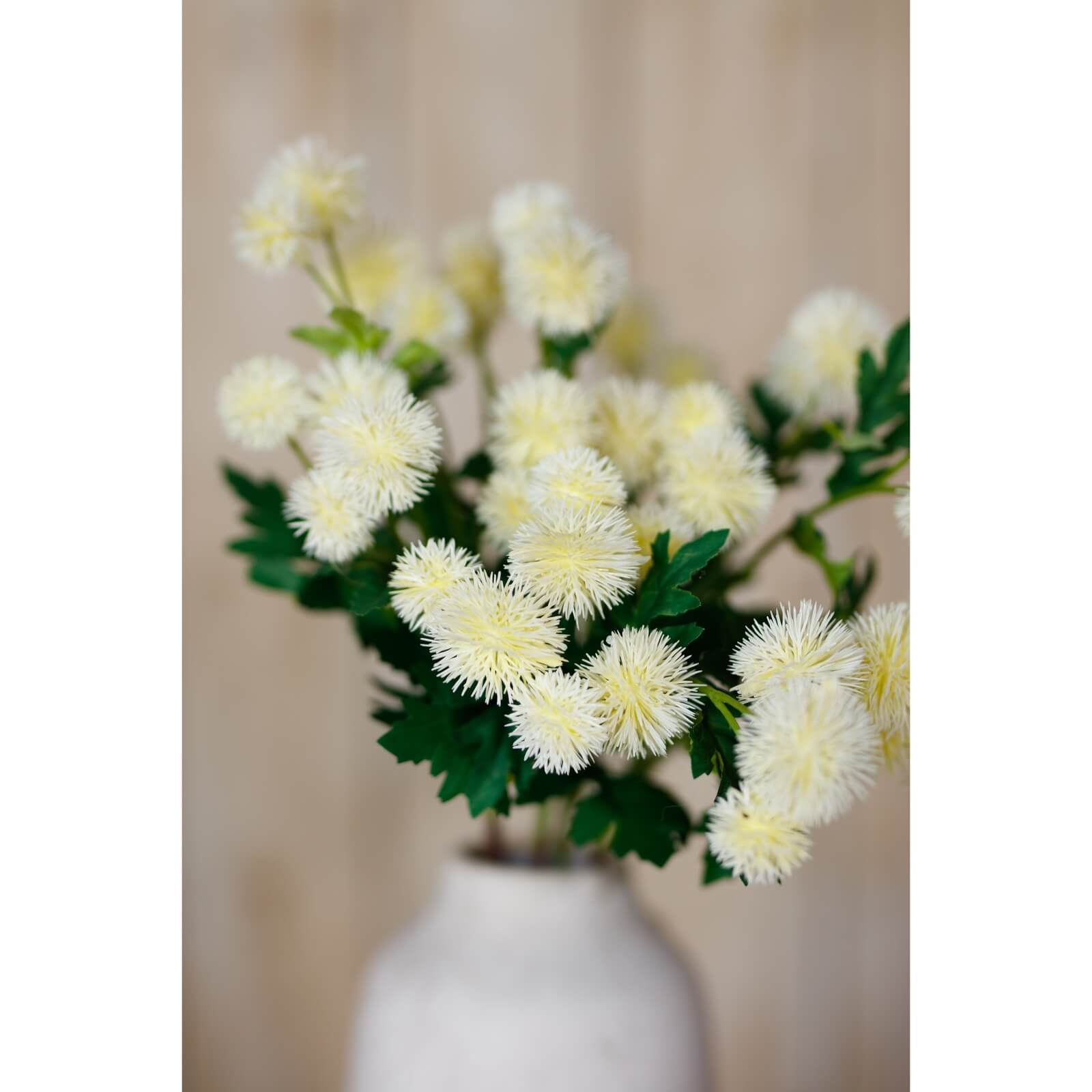 Handcrafted cream faux globe thistle spray with lifelike texture, 56cm tall, perfect for modern or rustic home decor. by Sostter at brixbailey.com