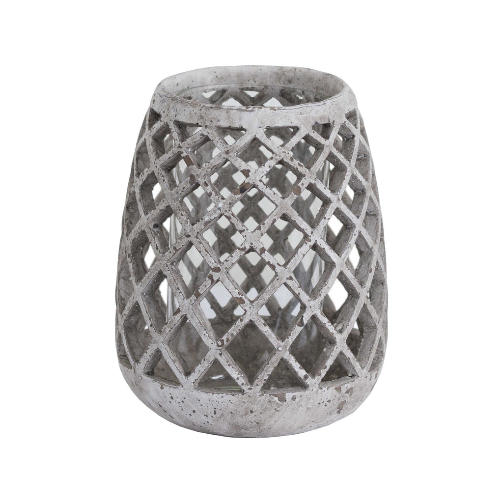 Large conical ceramic lattice hurricane lantern in natural stone, emitting soft light patterns through decorative cutouts. by RoomLondon at brixbailey.com