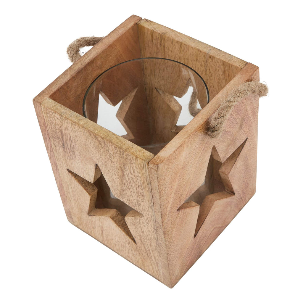 Handcrafted wooden star tealight holder with celestial design, casting warm boho shadows for home decor. by RoomLondon at brixbailey.com