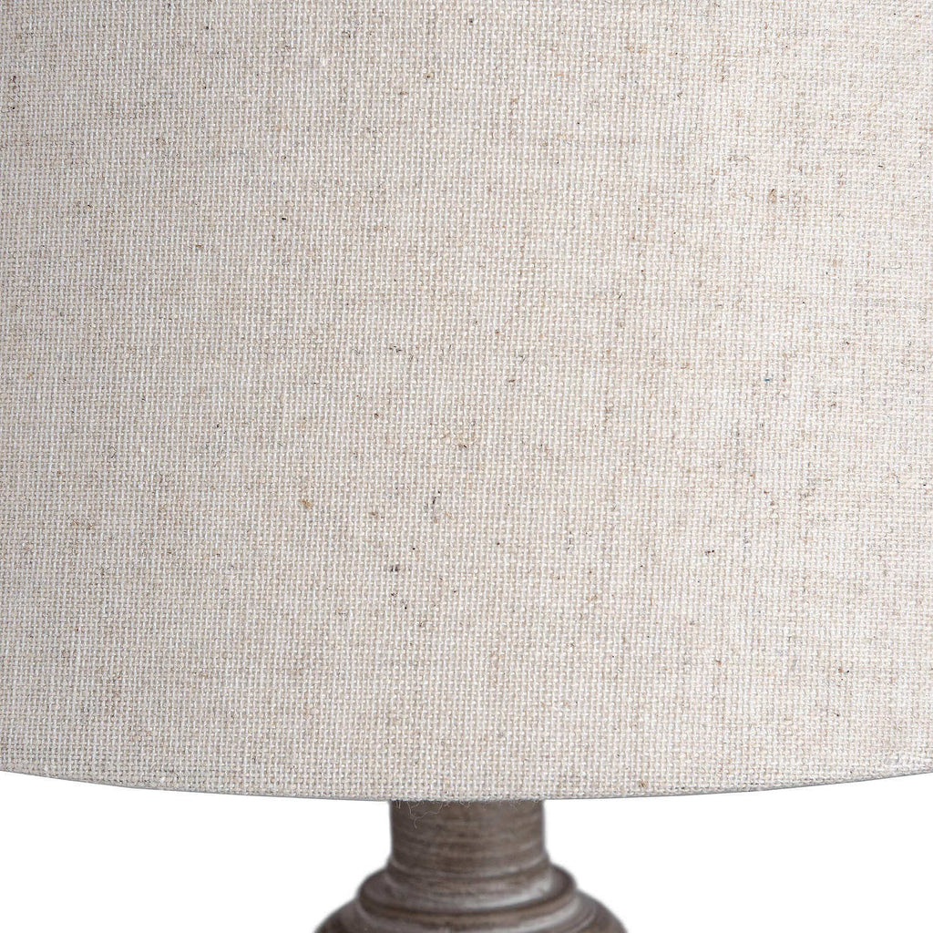 Rustic table lamp with whitewashed wood base and linen shade, warm beige tones for cozy ambient lighting. by Sostter at brixbailey.com