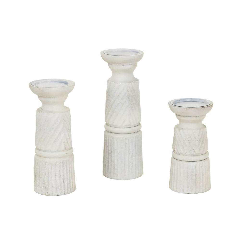 Hand-carved white wooden candle holder with geometric patterns, 20cm tall, casting ambient light for modern or traditional decor. by RoomLondon at brixbailey.com