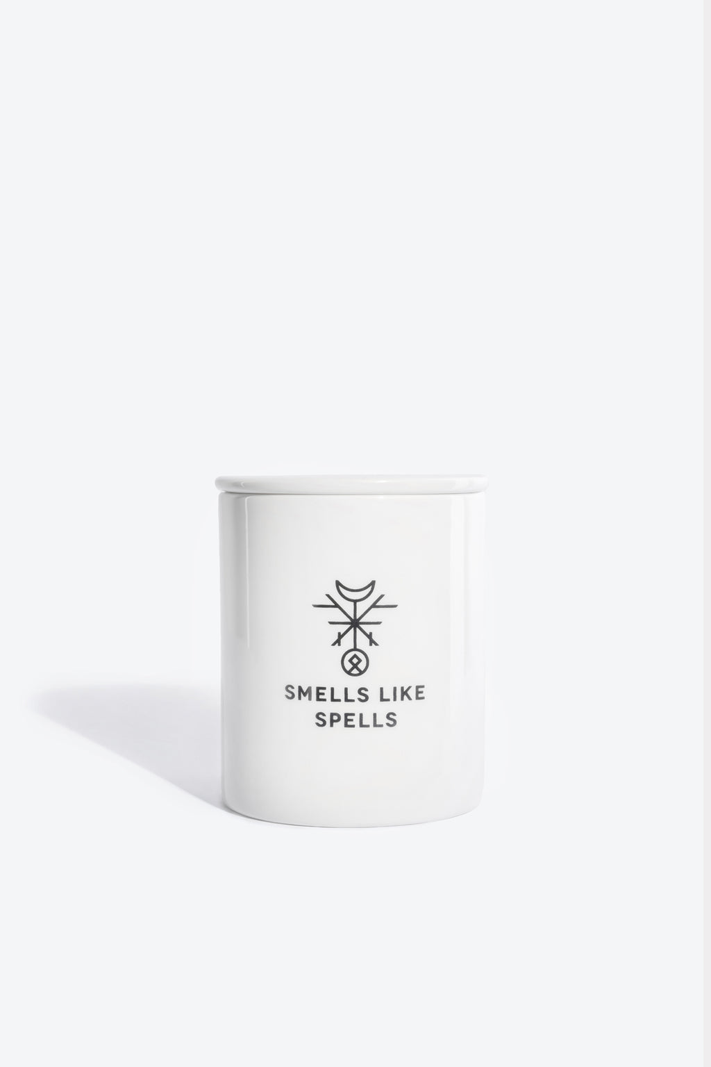 elegant porcelain judgment candle with tarot card and soft glow on a marble surface