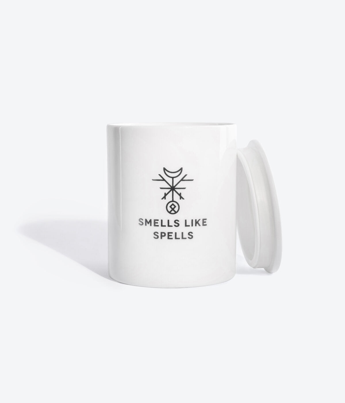 elegant handmade porcelain moon tarot candle glowing softly on a dark surface