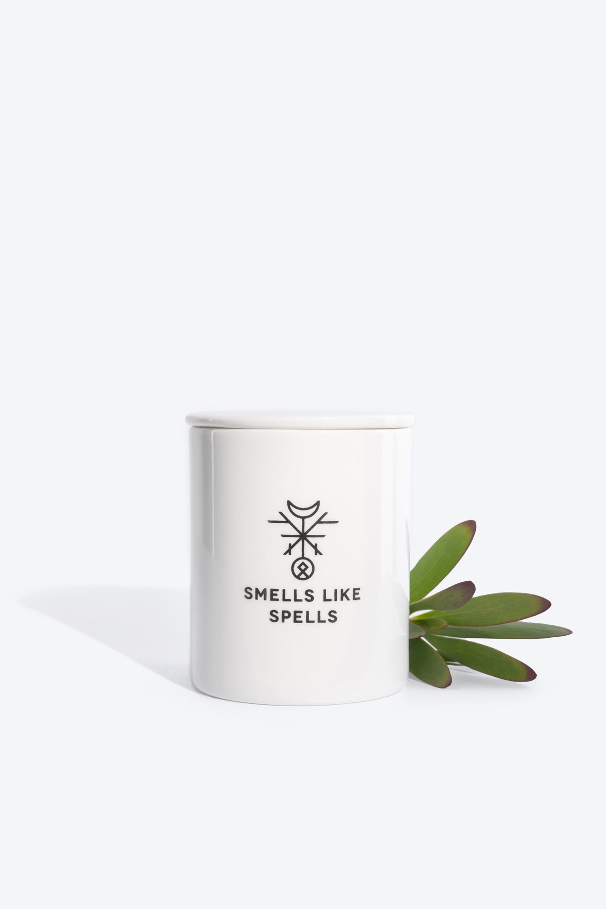 bold judgment scented candle in a handmade porcelain jar, glowing with transformative eucalyptus and lemongrass energy