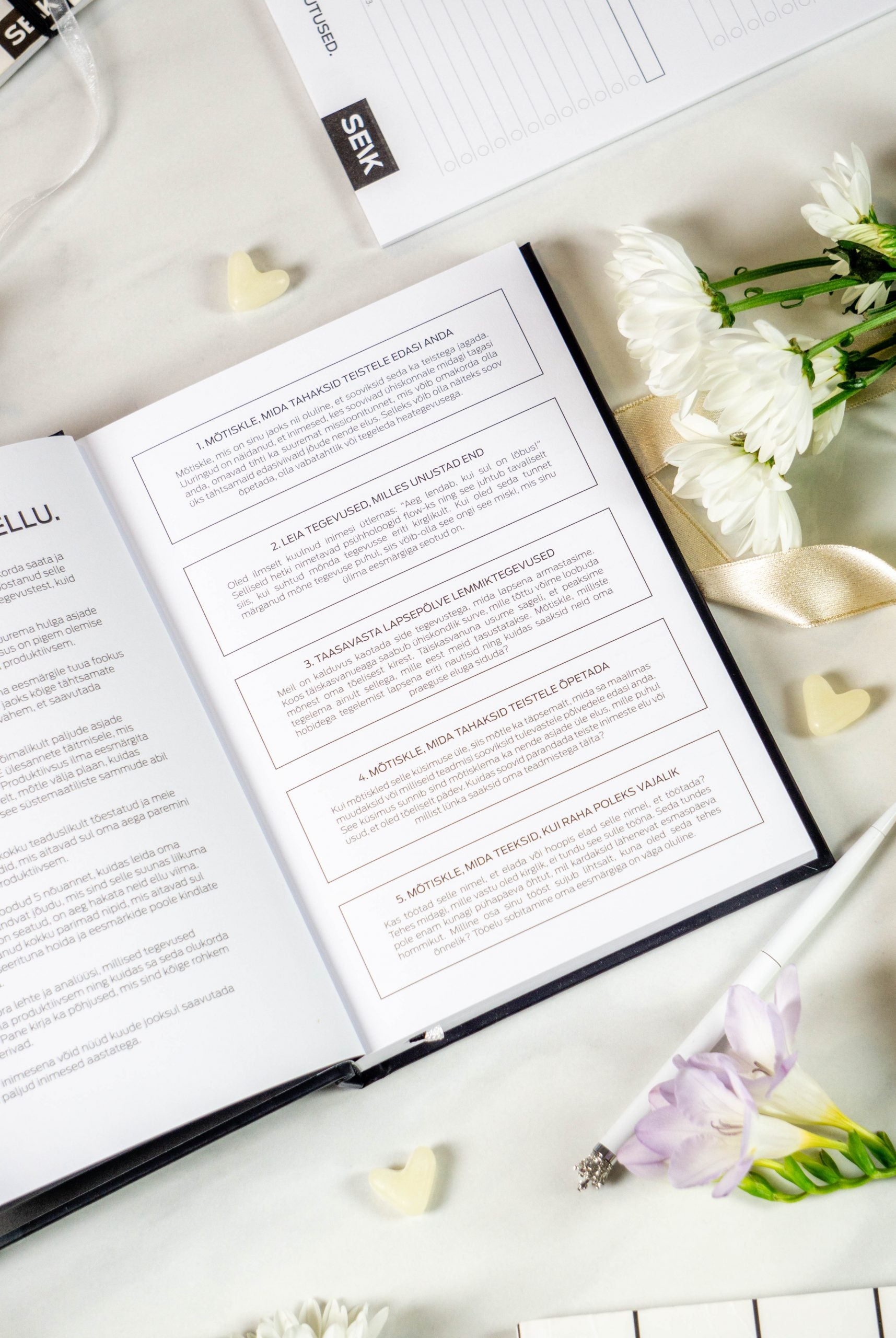 elegant undated productivity planner open on a weekly spread with refined typography