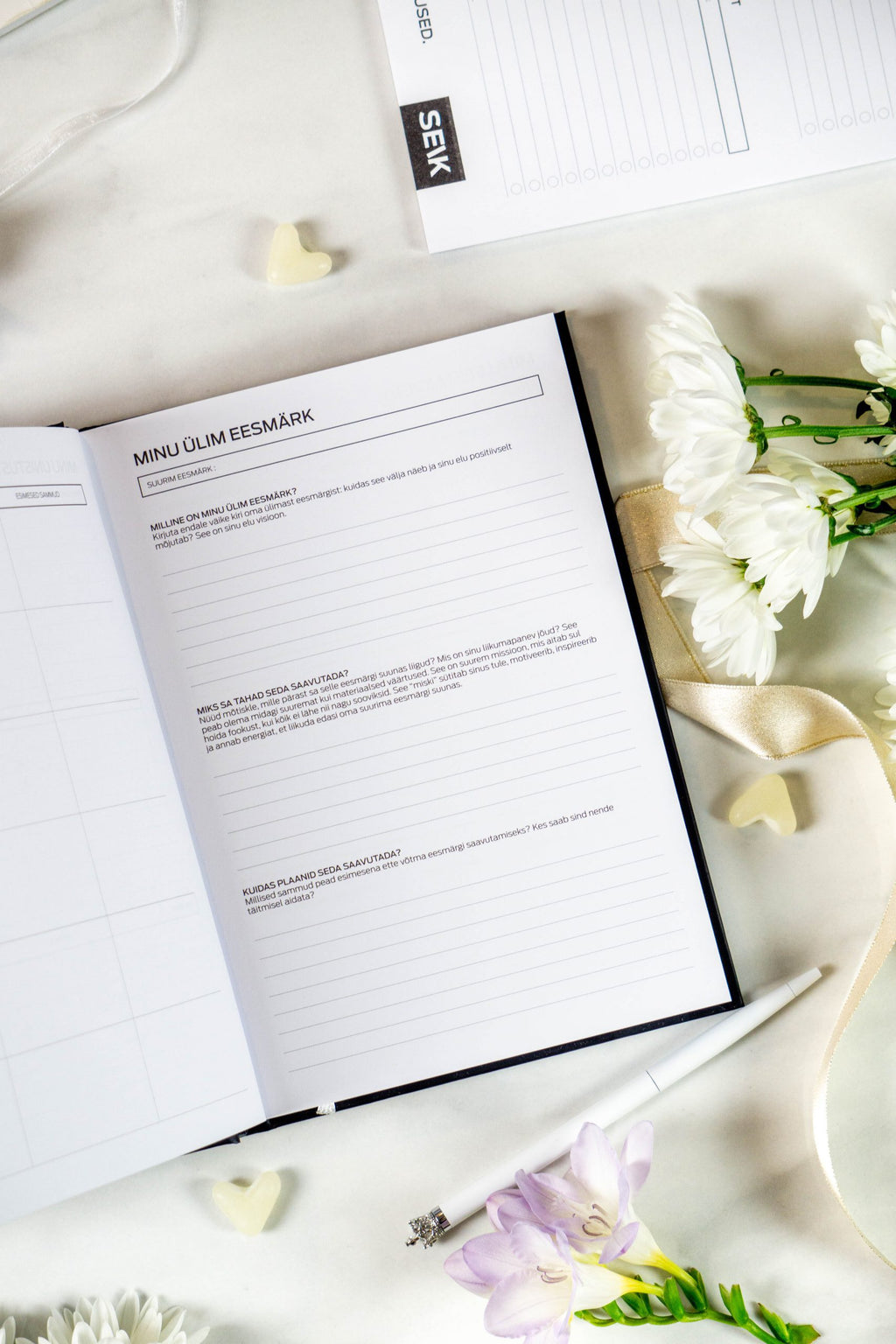 functional undated productivity planner open to a weekly spread on a wooden desk