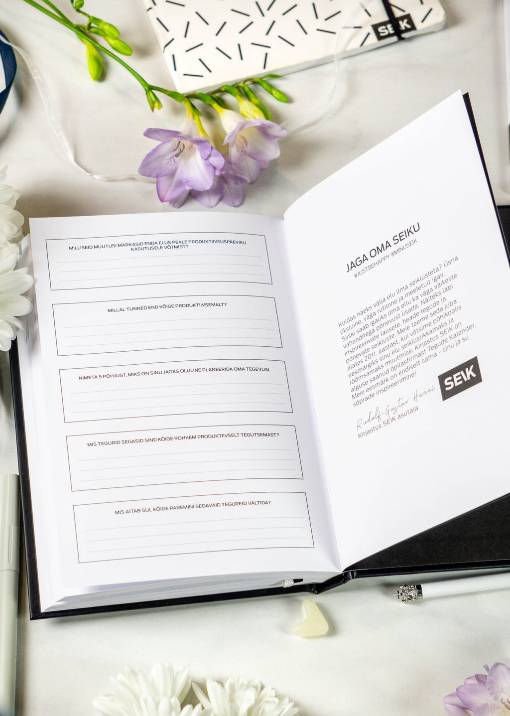 a productivity planner open on a desk with morning light highlighting its undated weekly layout