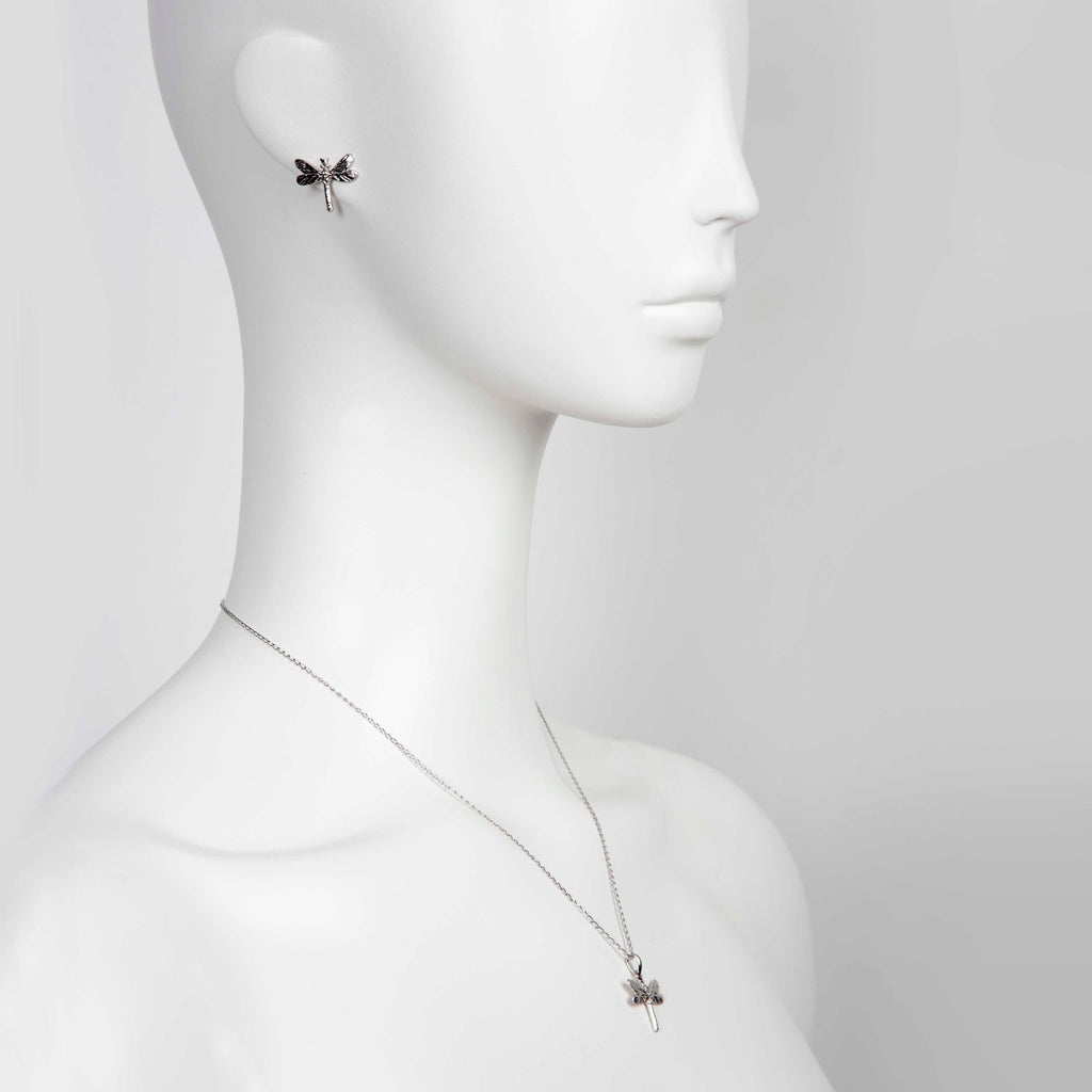 softly lit dark dragonfly pendant on a silver chain, a comforting gift of strength