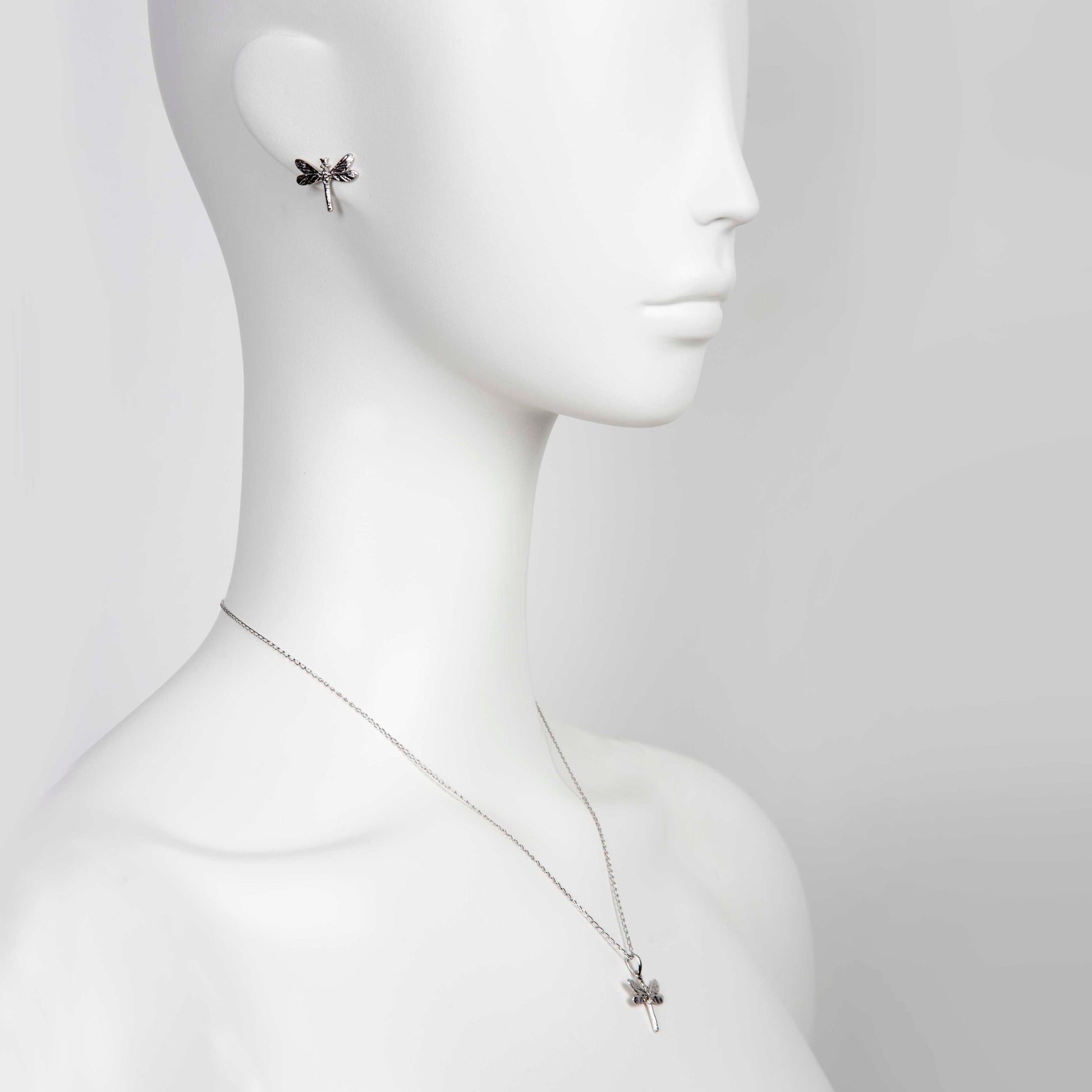 softly lit dark dragonfly pendant on a silver chain, a comforting gift of strength