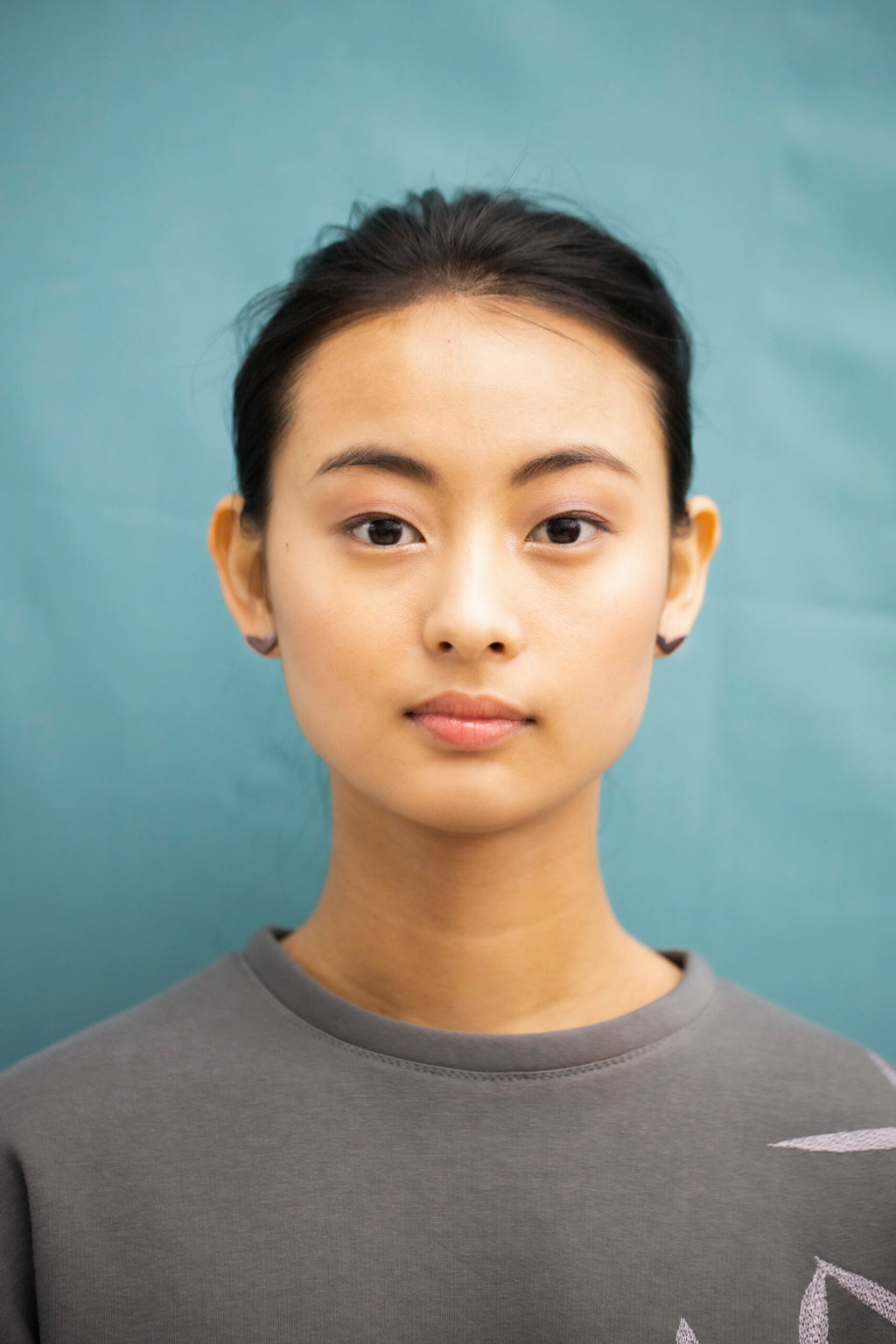 playful close-up of vola purple eco earrings sparkling in warm light