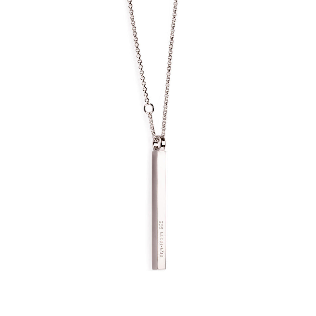 softly lit silverbar necklace resting on a delicate fabric, a comforting and elegant gift for her