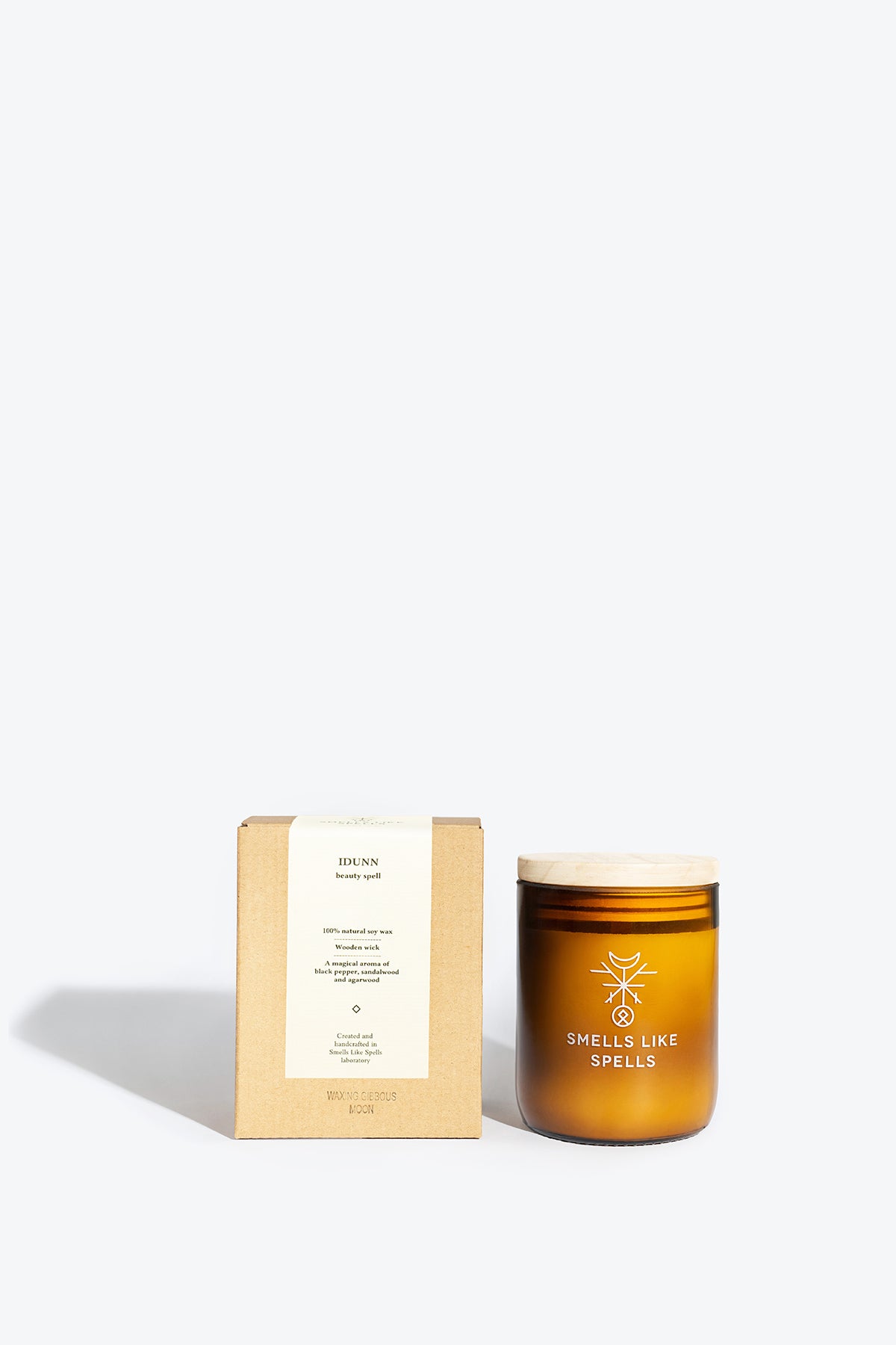bold amber jar of idunn's enchantment candle with a glowing wooden wick