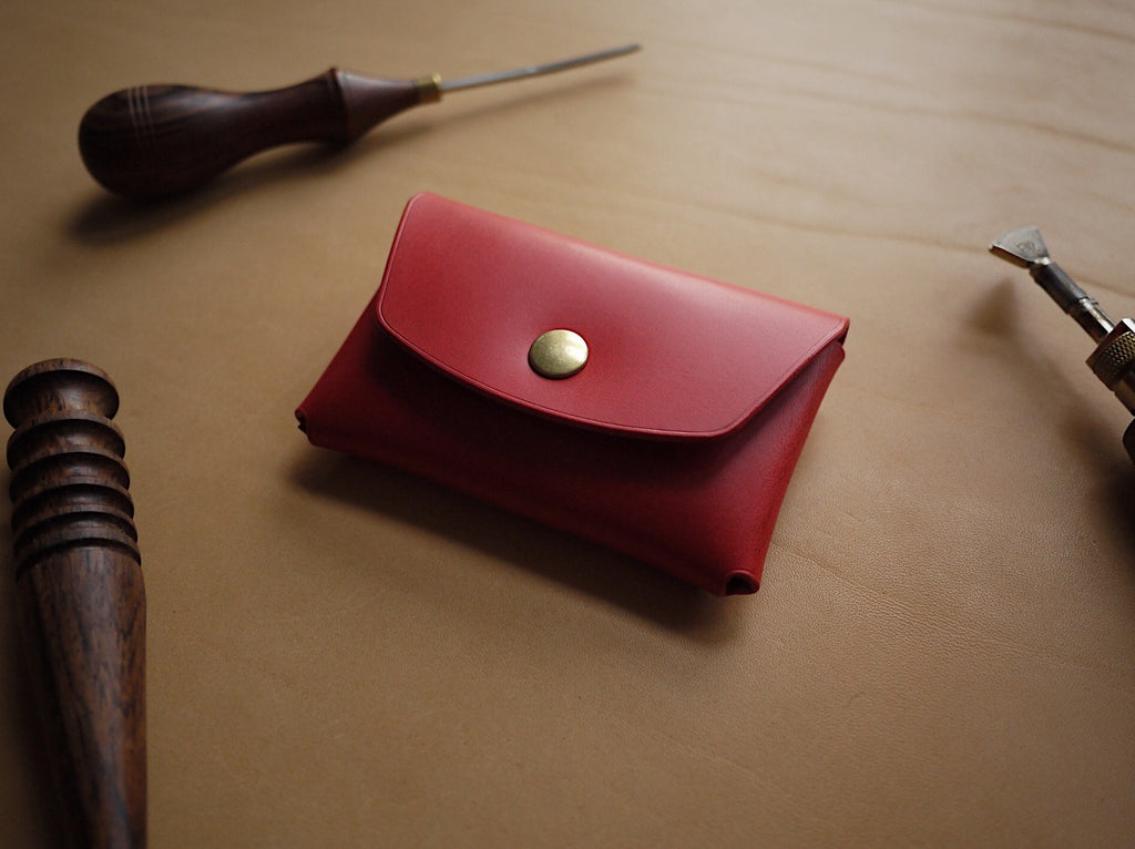 bold red handmade leather wallet open to show spacious card slots and polished edges