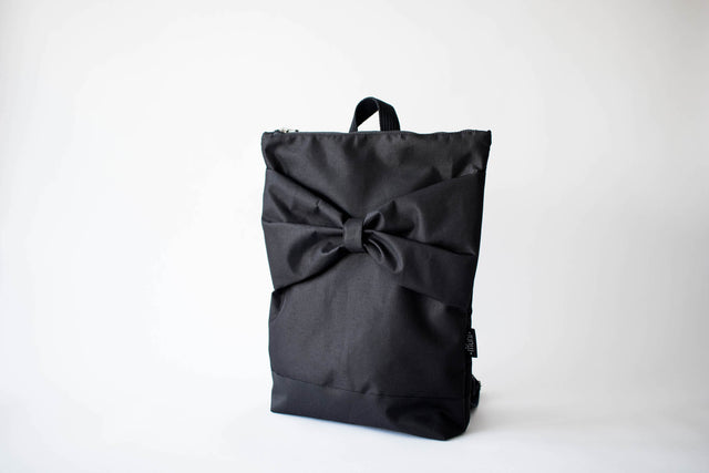 Chic Black Bow Backpack – Stylish & Waterproof for Daily Use by Muni at www.brixbailey.com