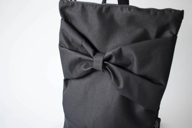 Stylish Black Bow Backpack – Waterproof & Versatile by Muni at www.brixbailey.com
